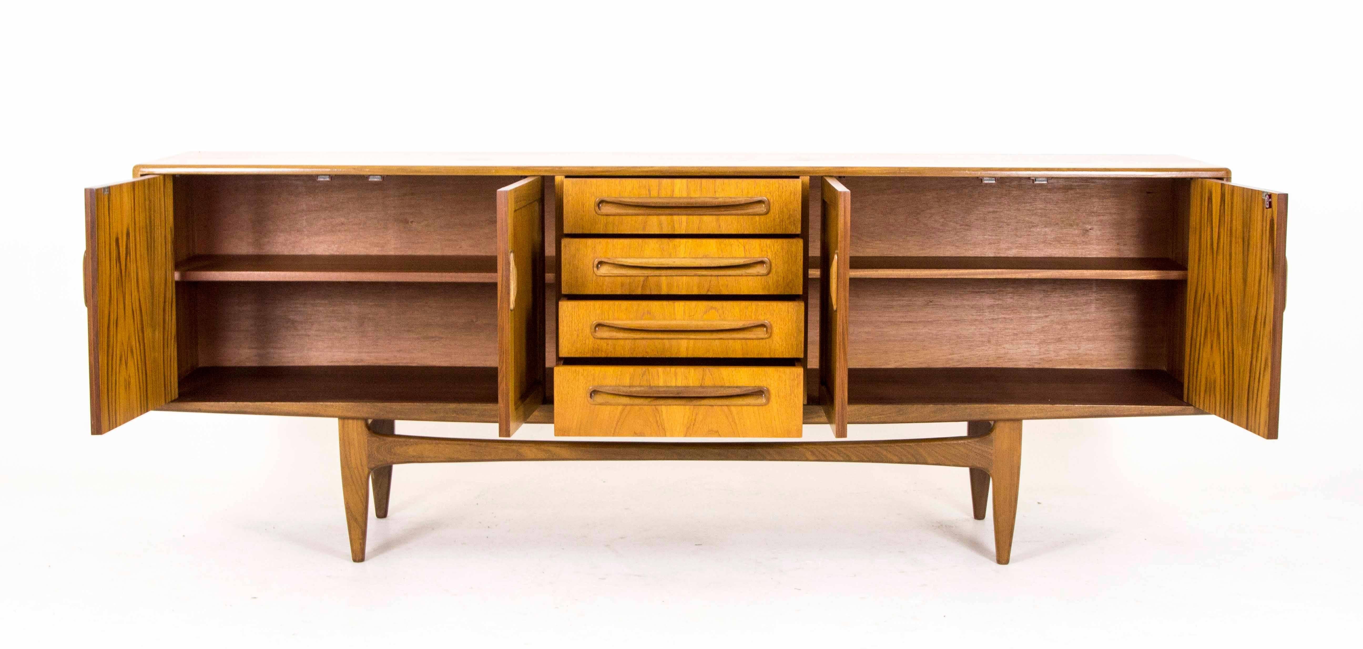 England
1960
All original
Designed by Victor Wilkens for GPlan
Part of the Fresco Range
Four central drawers
Flanked by two double door cupboards
Top drawer with Felt and Sections for Cutlery
Ending on shaped base
Very good
