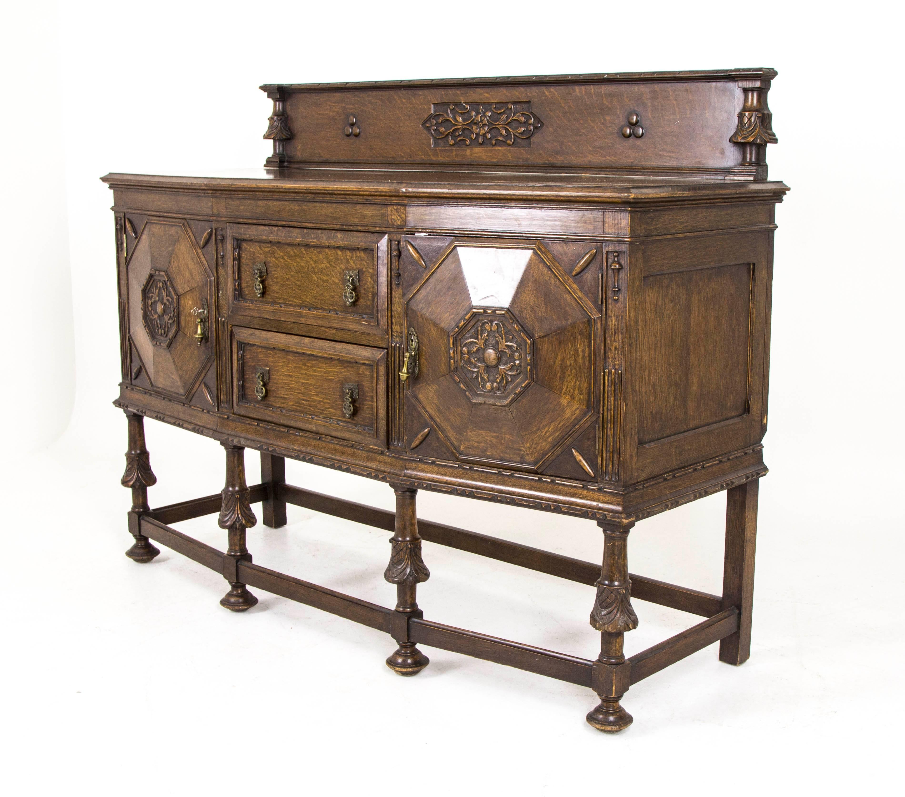 Scotland
1920s
Solid oak construction
Original medium oak finish
Tall decorative back
Shaped top with moulded edges
Below two centre drawers
Flanked on either side by cupboards with shelving and slideout decanter drawer
All supported by
