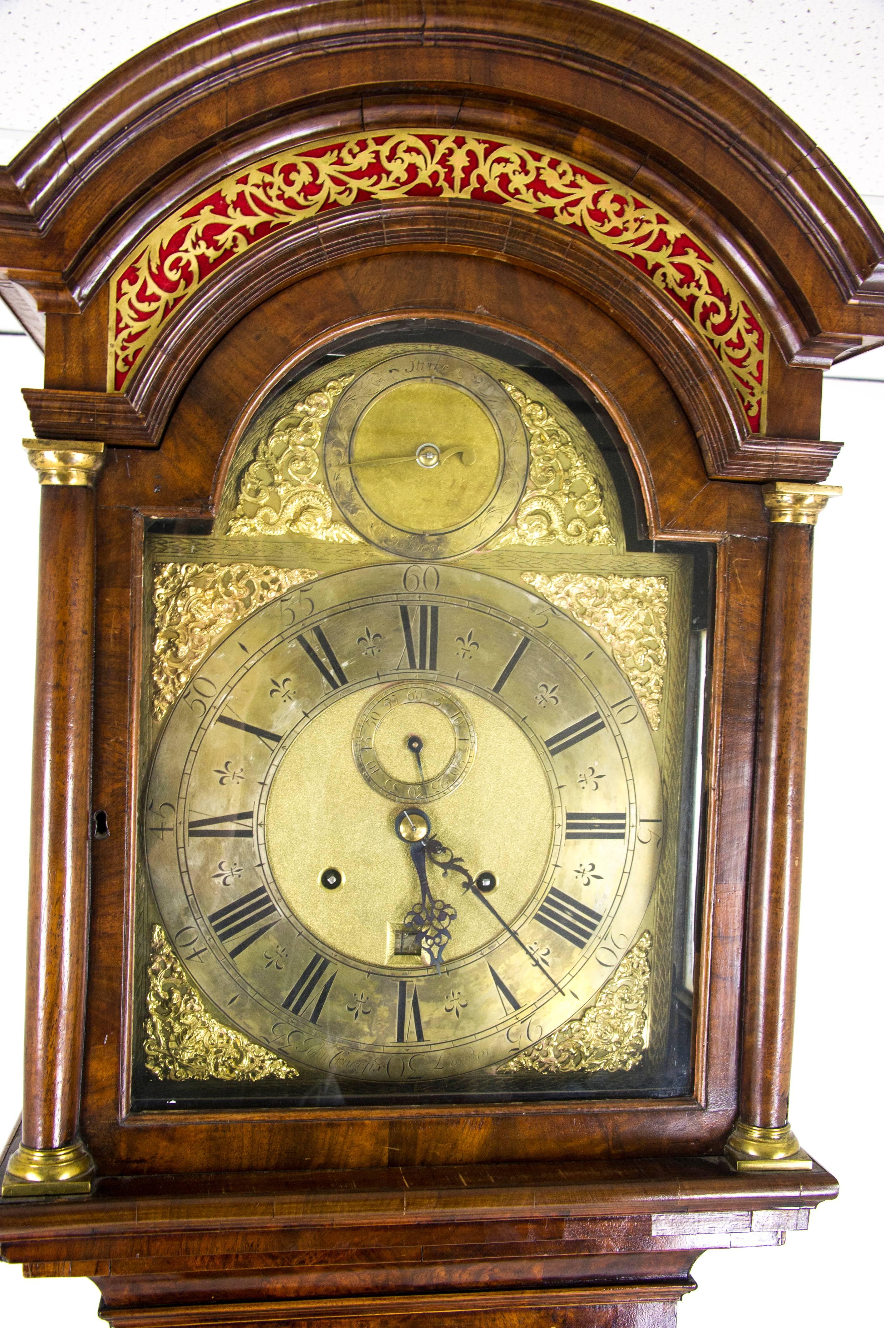 Antique grandfather clock John Crucefix of London, 1720 walnut long case clock.

England, 1715-1725.
Clean and well proportioned
Arched dome hood with a panel of brass fretwork and fixed pillars
With anchor escapement and strike on a