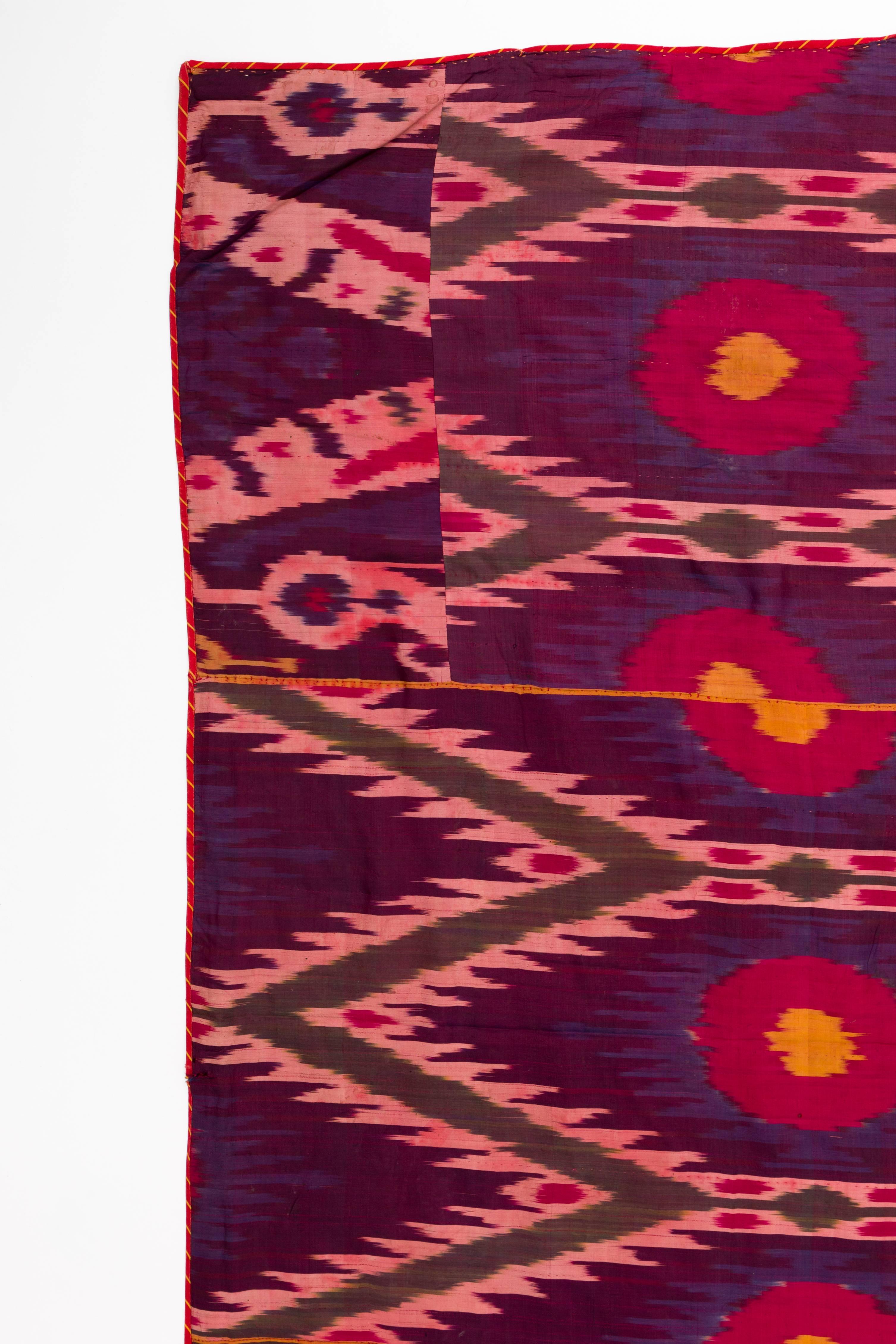 Late 19th century silk tribal Ikat weaving panel from Uzbekistan, Central Asia.
Luxurious over saturated magenta, purple, gold, green and pink. Reverse side is backed with its original 19th century gorgeous paisley cotton. Light wear to edges. Minor