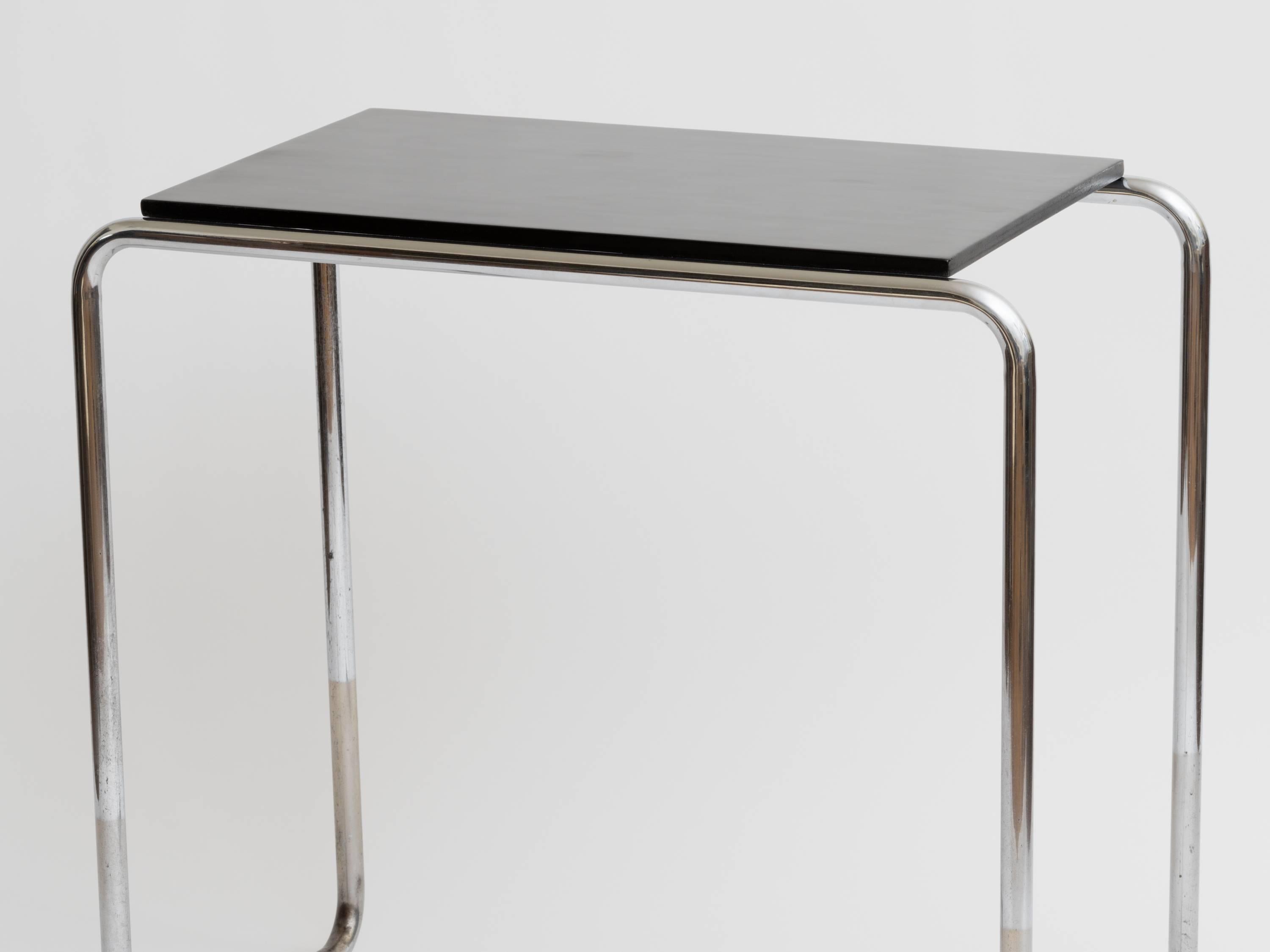 Original 1930s black lacquered table with tubular metal legs in the style of Marcel Breuer. Has a variety of uses, console, bar, small desk or vanity.