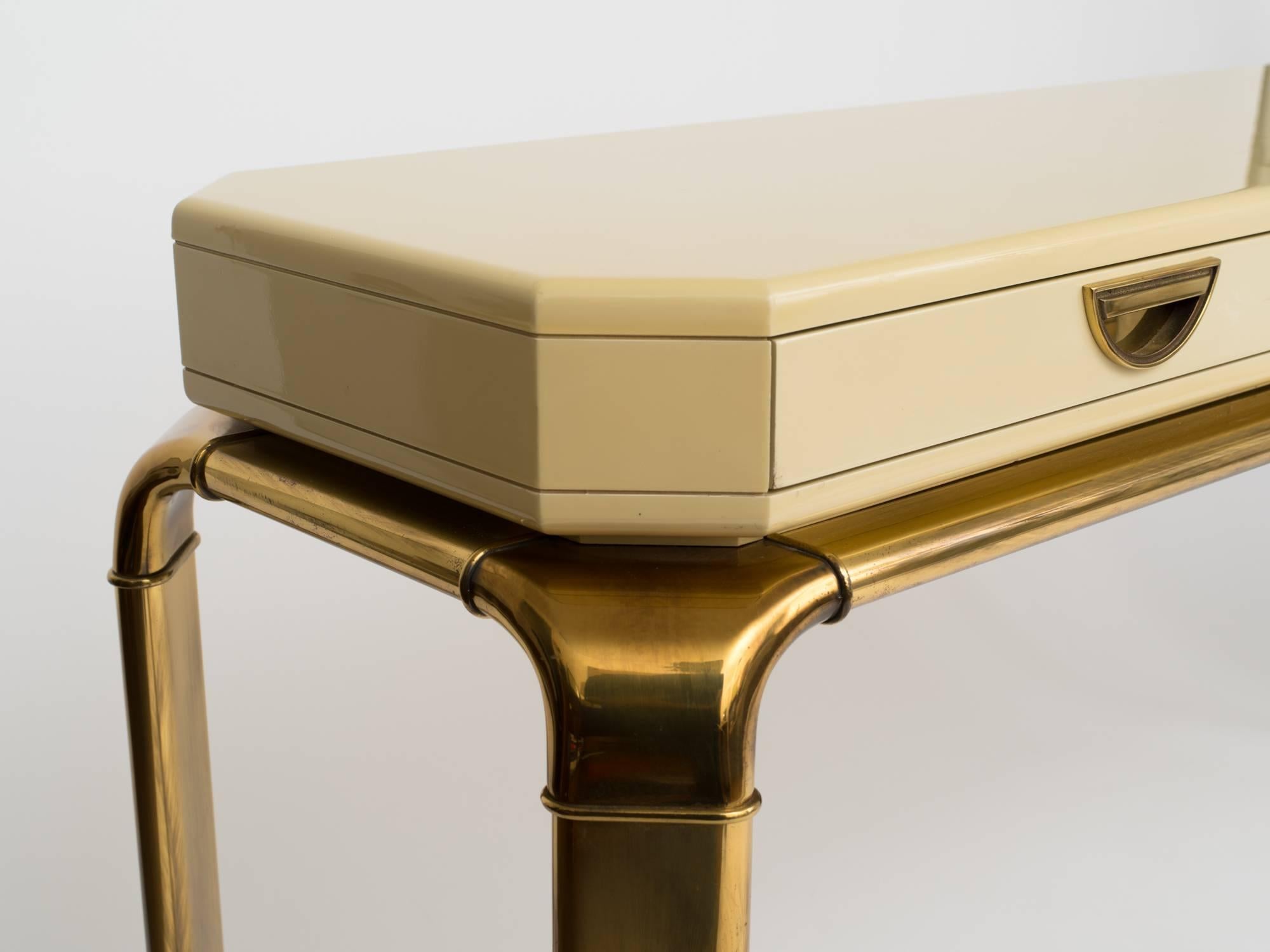 1970s ivory lacquer console table with brass drawer pulls and frame. Mastercraft for John Widdicomb, Grand Rapids. MI.