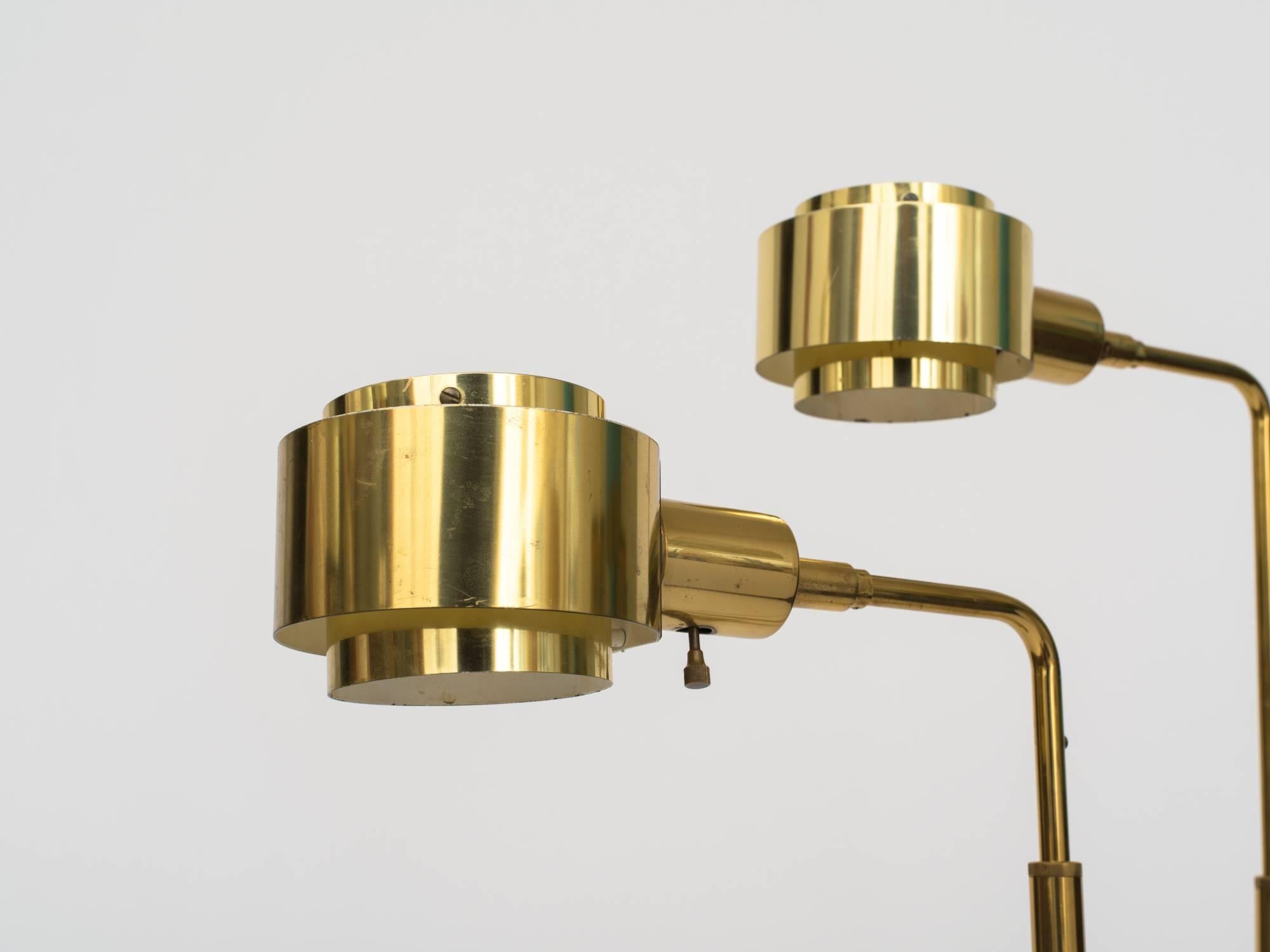 Pair of 1970s brass reading lamps with adjustable height and rectangular bases. Circular shades pivot to direct light. Stamped, Koch & Lowy.