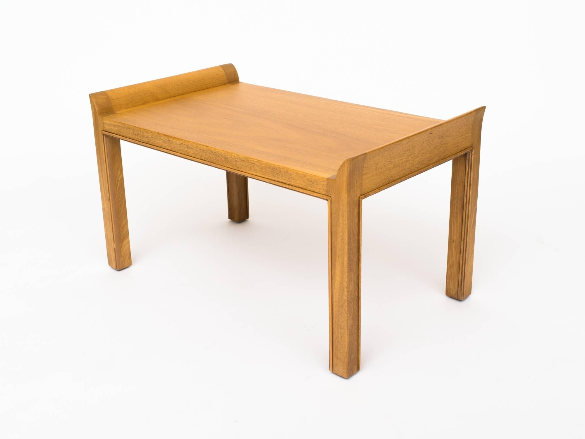 Classic Tommi Parzinger mahogany bench with gracefully curved sides. Legs and frame are finely detailed all around.