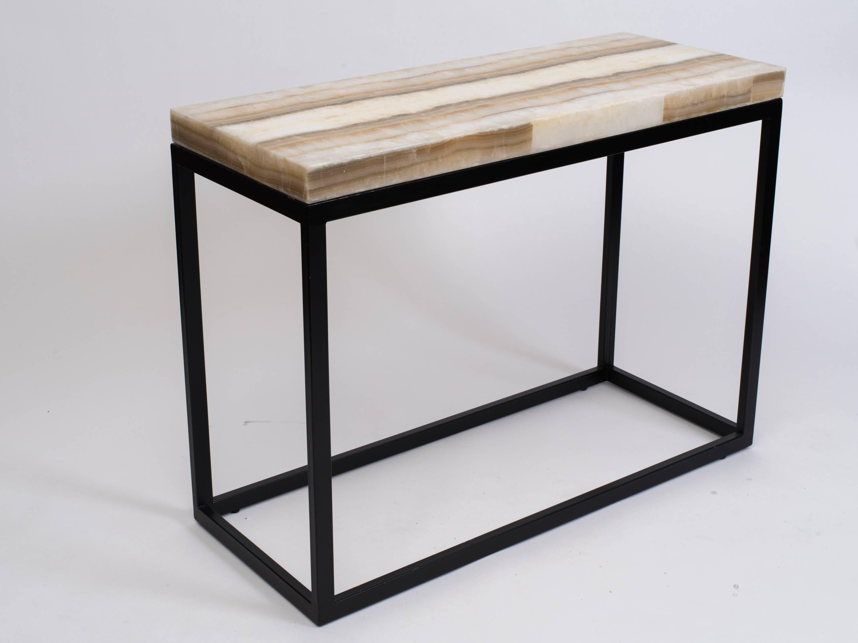 Gorgeous natural ribbon onyx top console table on black finish metal shadowbox frame base. 