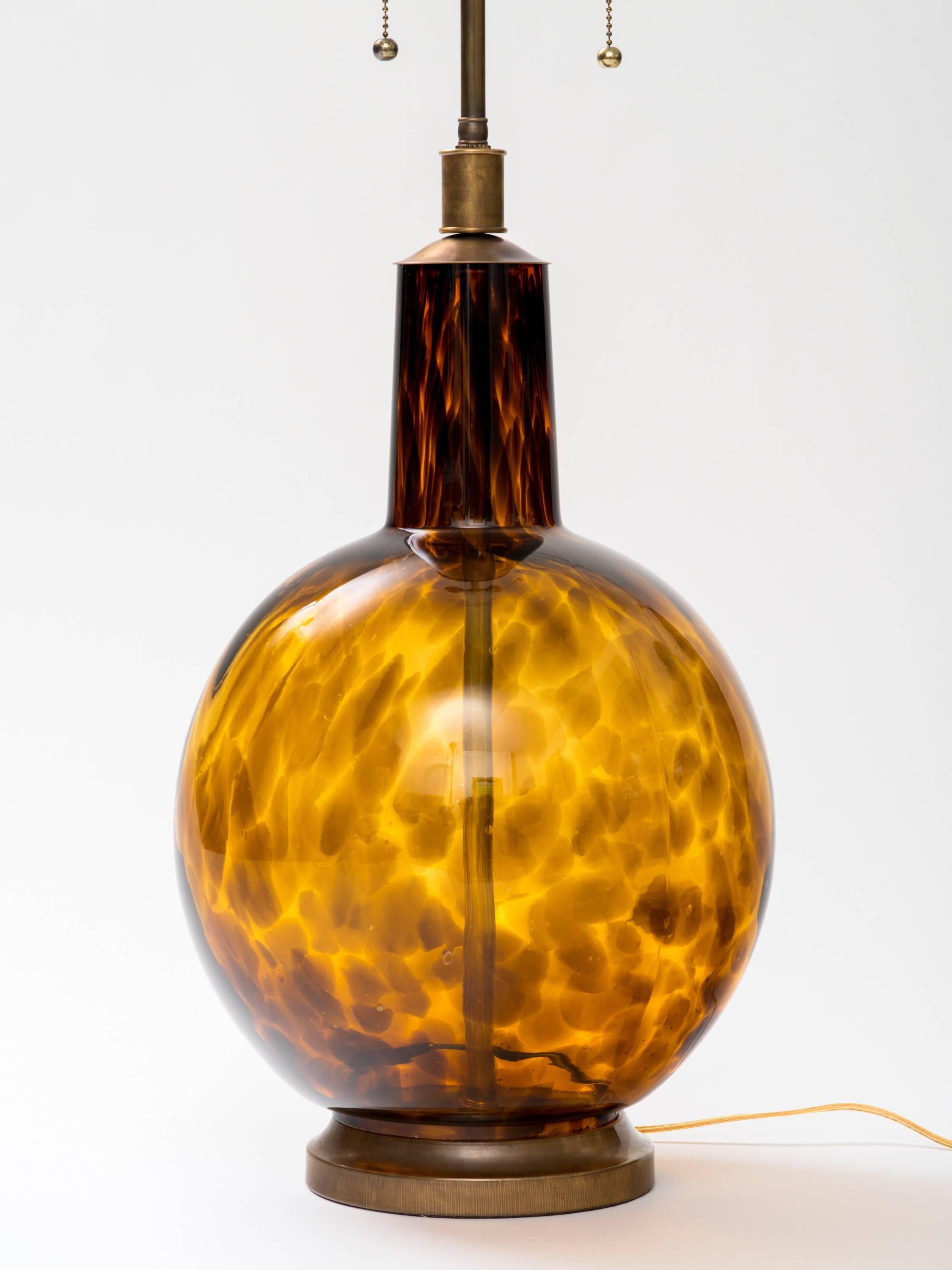 Pair of handblown Italian tortoise shell glass lamps. Newly rewired, with solid brass patinated hardware. Double socketed with pull chains. Not UL listed.
Lamp body measures 21