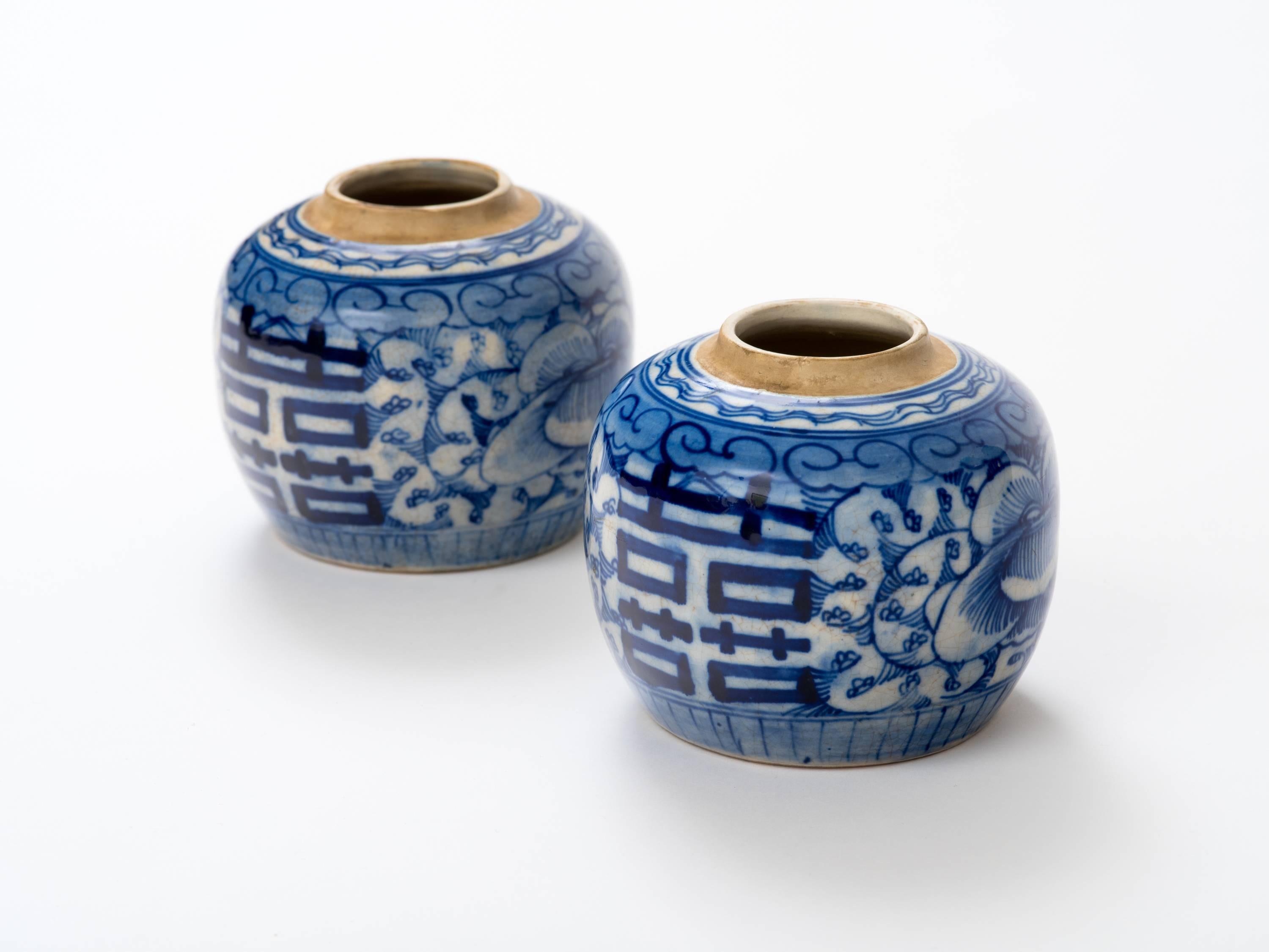 Antique 19th century pair of blue and white ginger jars hand decorated with lotuses and double happiness symbols.