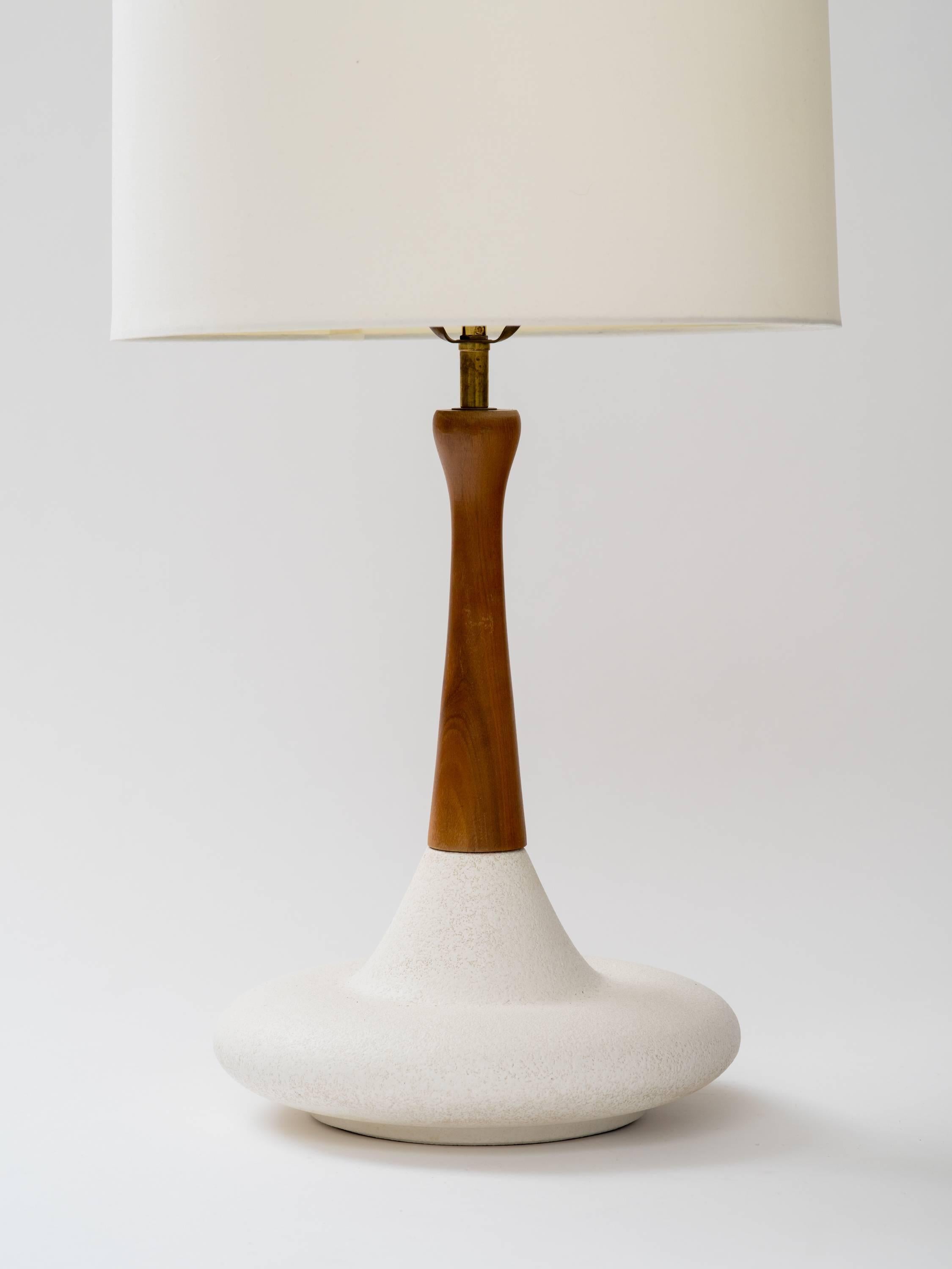 Pair of walnut white glazed ceramic bottle form lamps. Lamp bodies measure 16 inches height, overall height to finial, 28.5 inches. USA, circa 1960s.

  