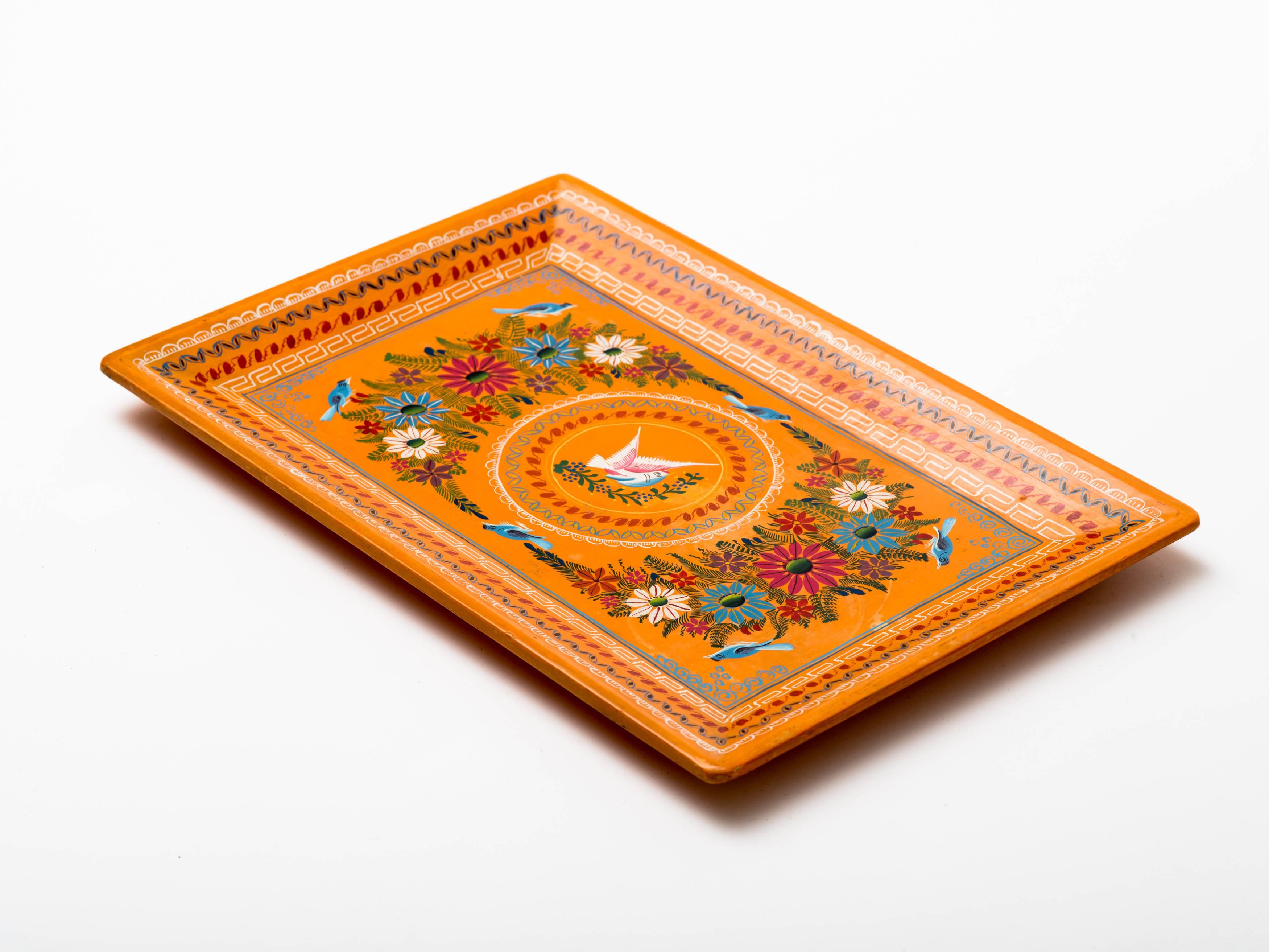 Hand-painted and lacquered Mexican serving tray with floral design surrounding central medallion with winged dove. Geometric design border. Lacquered finish on reverse. Olinala, Guerrero, Mexico, circa 1960s.
