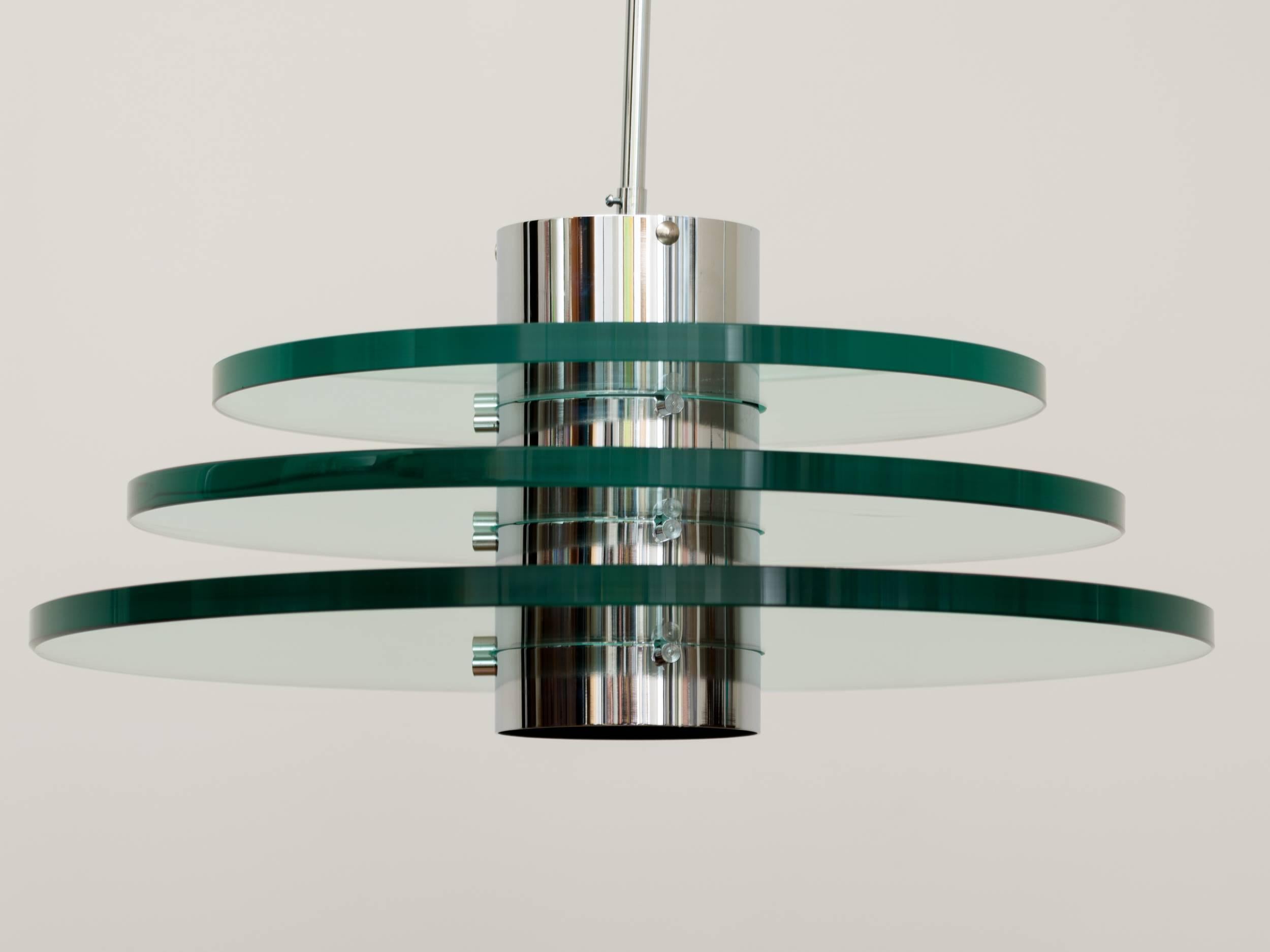 Postmodern triple glass disc chandelier with nickeled central column and stem.
Glass discs measure three quarters inch thick. They slide into central column, held with metal hardware. Purchased directly from original owner.
 