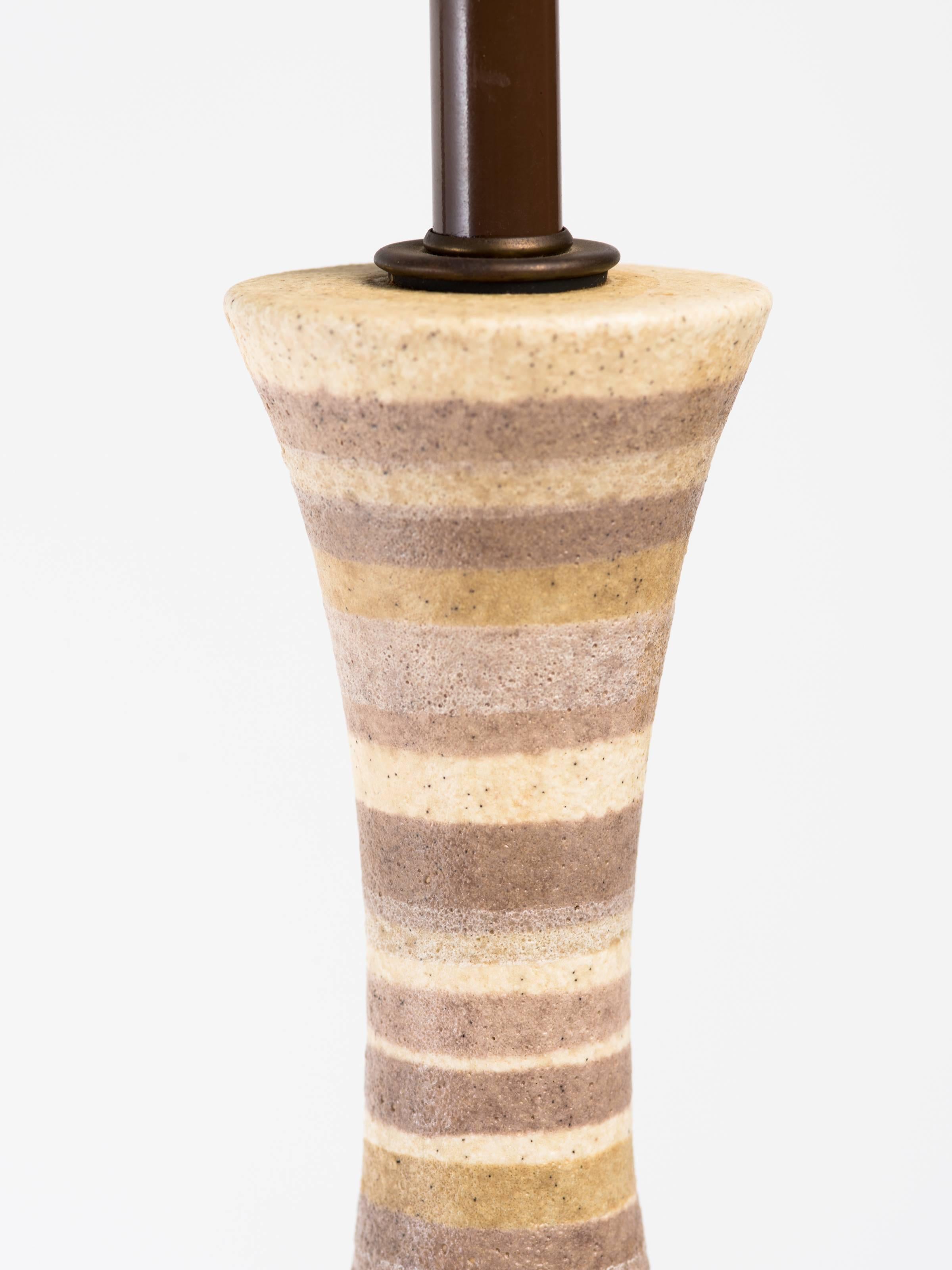 Italian 1950's salt neutral stripe glazed ceramic lamp on circular walnut base. 
Overall height measures 38 inches, lamp body measures 23.5 inches height.