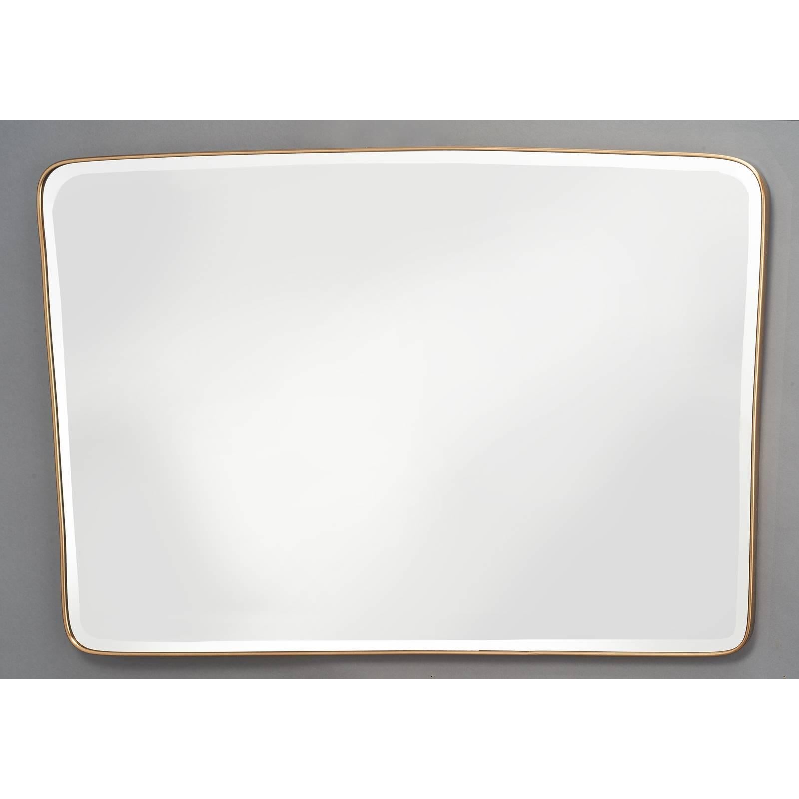 Italy, 1950s.
Large tapered and shaped horizontal brass mirror with rounded corners.
Bevelled glass.

Measures: 46 W x 31 H.
