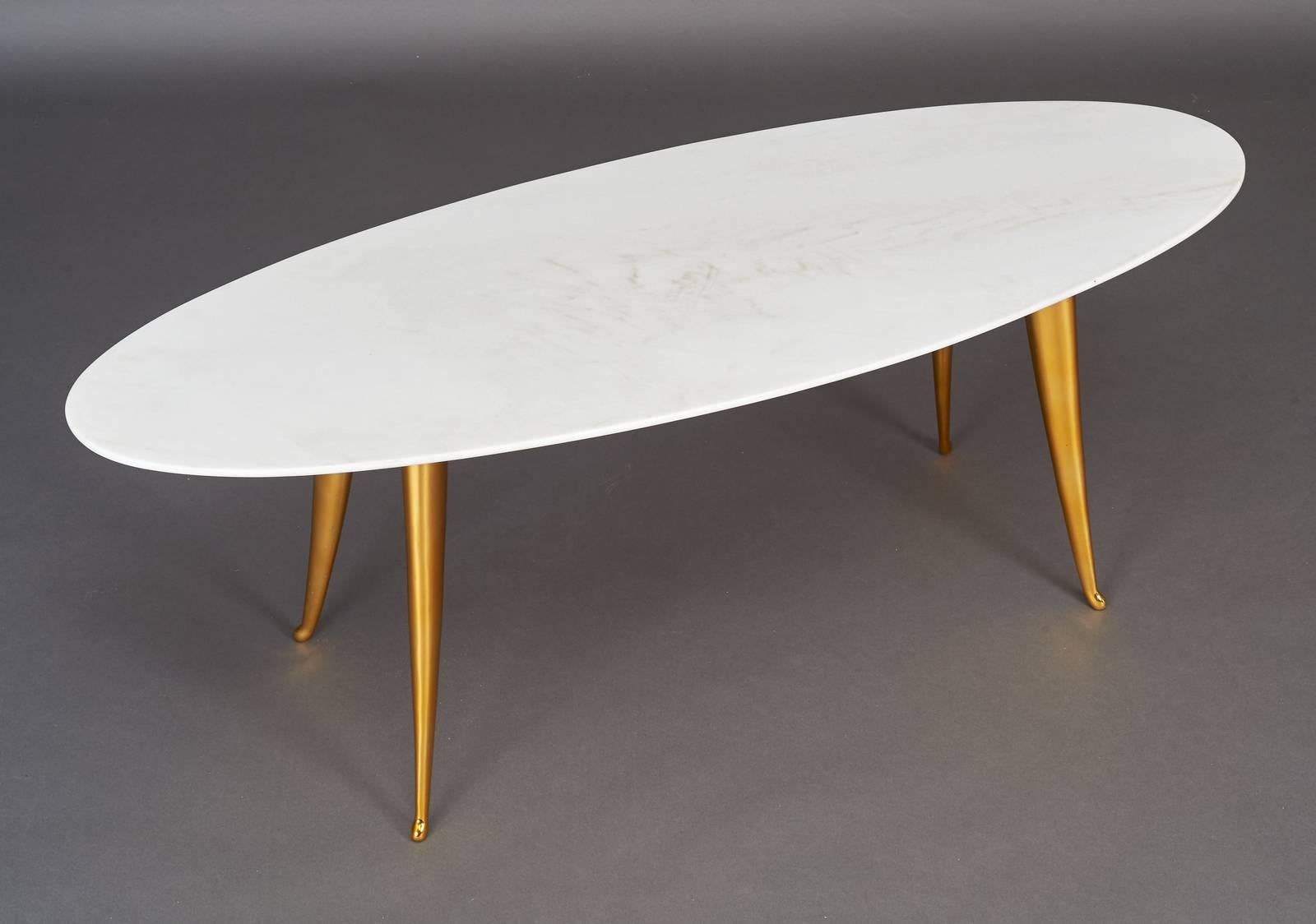 Italy, 1960s.

Beautifully cast polished bronze four-legged coffee table with oval Carrara marble top with tapered edge.

Measures: 48 x 18.5 x 17 H.
