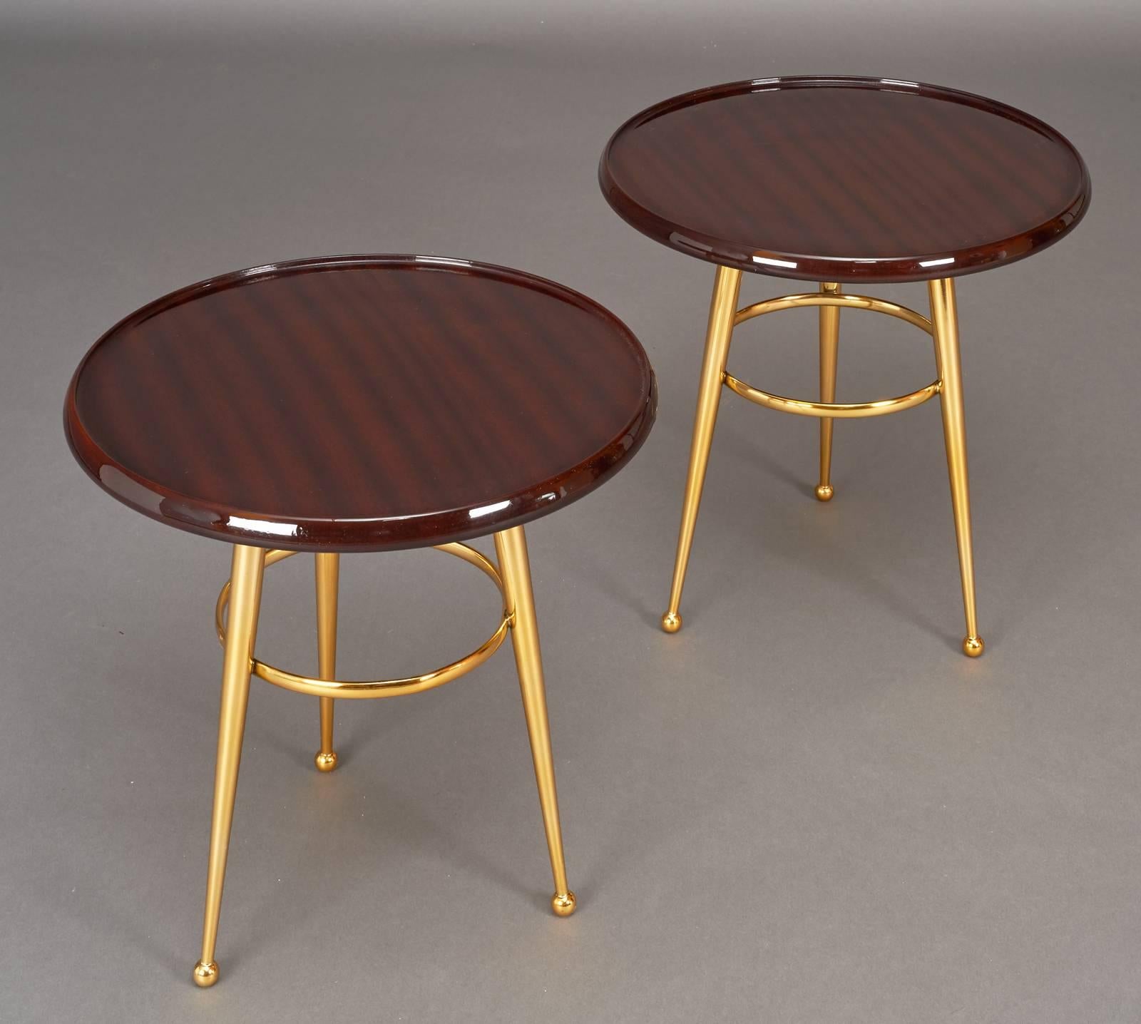 Italy, 1950s.

Pair of side tables.
Polished mahogany tables with tapered tripod polished brass base.

Measures: 17.5 Ø x 17 H.