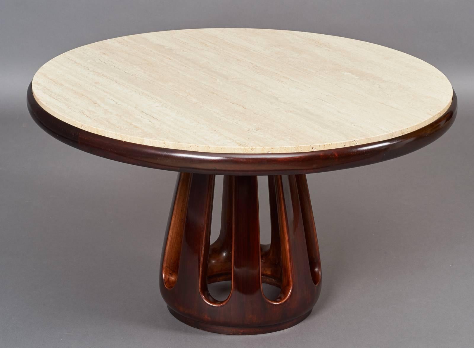 In the manner of Osvaldo Borsani,
Sculpted stained wood table of rounded forms with framed travertine top.
Italy, ca. 1950
Dimensions: 35 Diameter x 21 H.