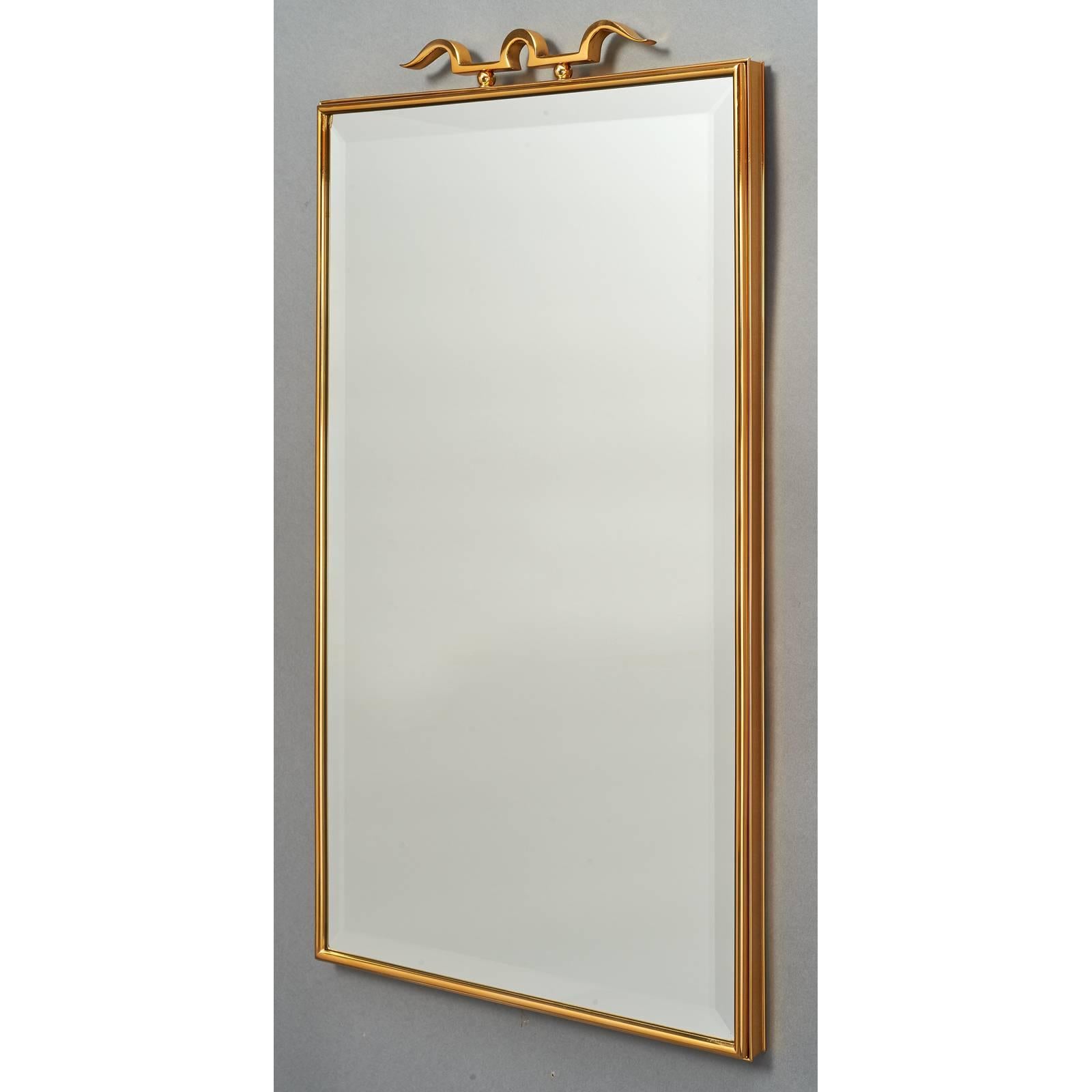 Italy, 1950s.
An elegant pair of beautifully tailored polished bronze mirrors with double frames and stylized crossbow motif, in the manner of Gio Ponti. Beveled glass.

Measure: 19.5 x 33.