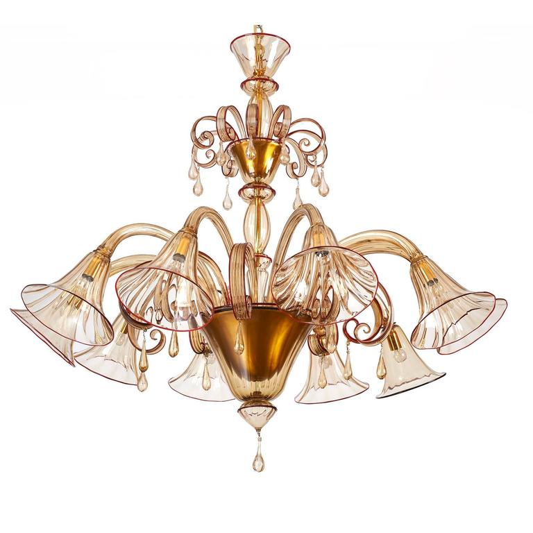 VENINI
A stunning early Venini Murano blown glass ten branch chandelier.
In fine straw glass with delicate ruby red edging, Italy, late 1920s.
Dimensions: 54 Diameter x 50 H
Can be mounted in variable configurations and heights.
Rewired for use in
