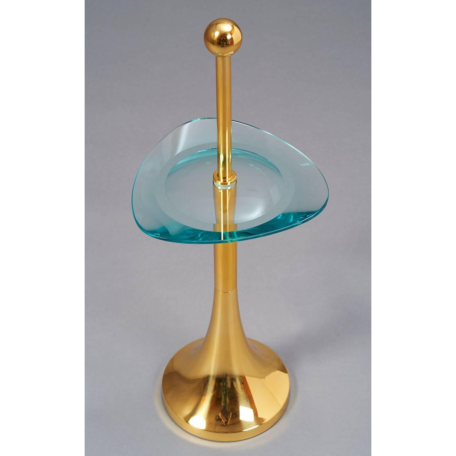 Italy, 1970s.
Pedestal side table in the style of Fontana Arte
with beautifully ground and double beveled triangular glass top.
Polished brass base.
Dimensions: 11 Ø x 18 H at glass tray/28 H overall.