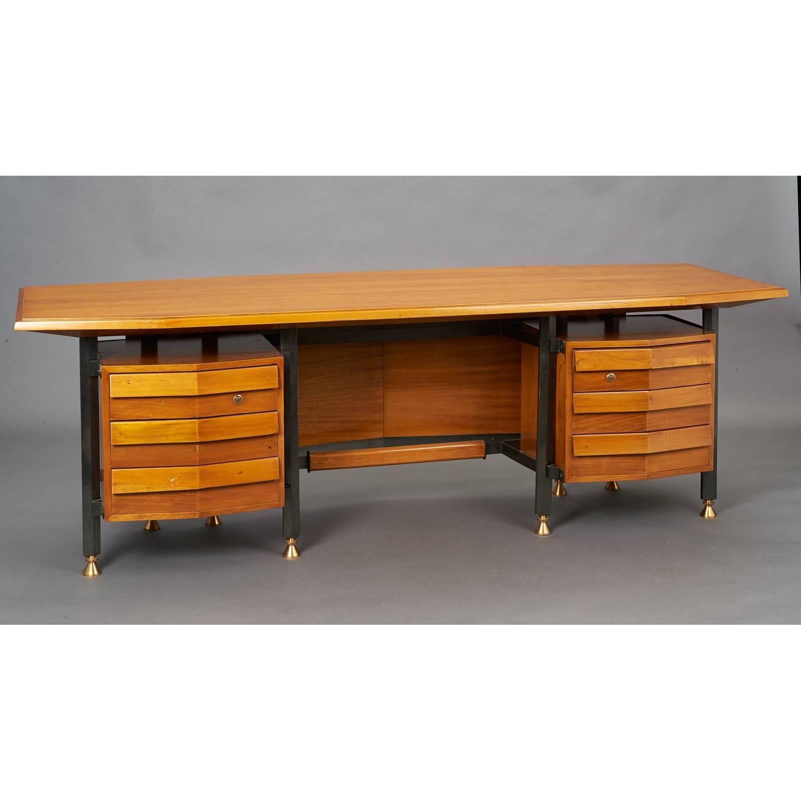 Italy, 1950s.
Spectacular 7.5' modernist desk with six angle faced drawers, the shaped writing surface with tapered ends, mounted on oxidized bronze legs repeating the tapered form of the desktop, with contrasting bronze feet. Angled modesty panel,