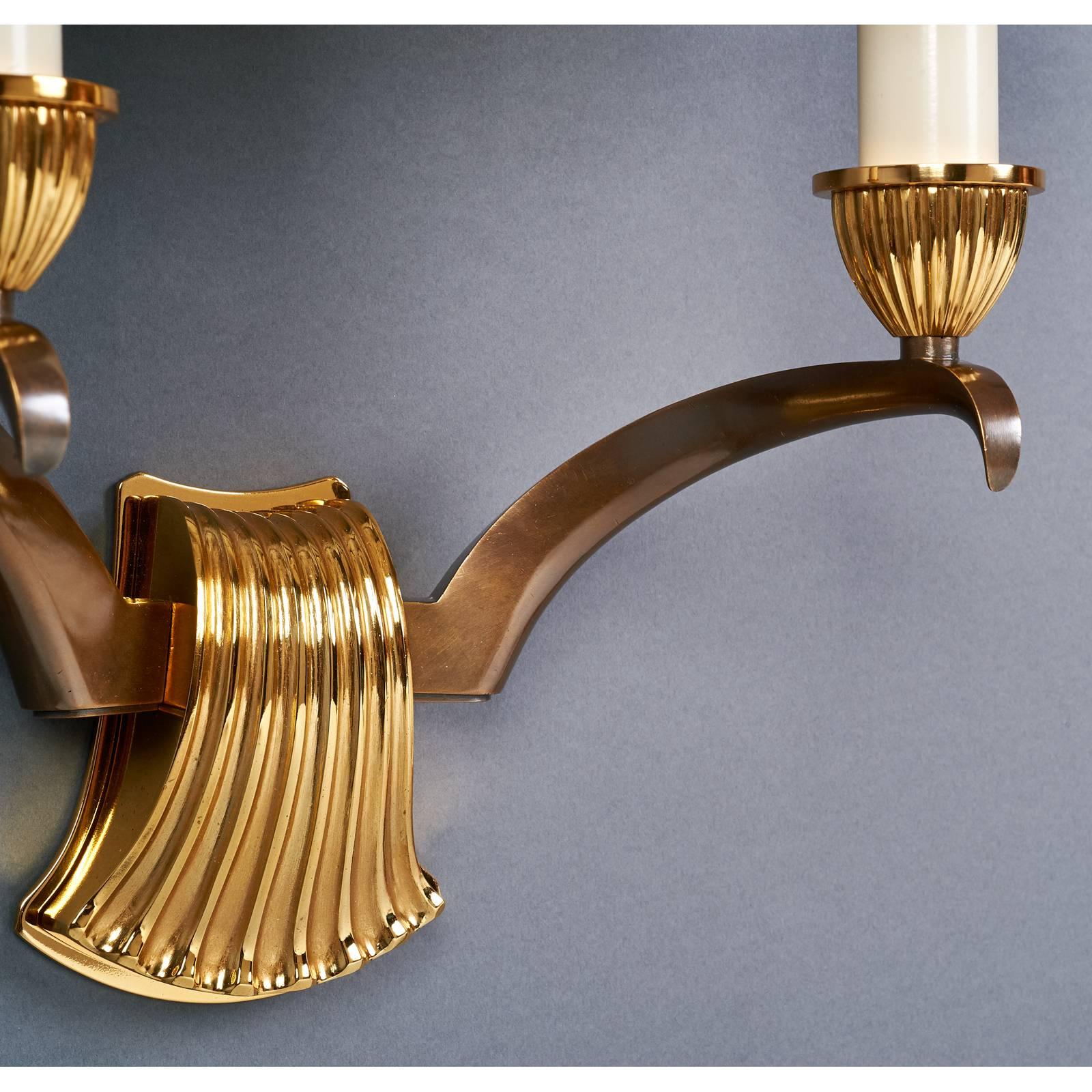 Genet Michon
A beautiful pair of two branch sconces with finely modeled scallop motif
and elegantly turned arms, in contrasting oxidized and gilt bronze.
France, 1950s
Dimensions: 13.5 W x 8 D x 18 H
Rewired for use in the USA with chandelier base