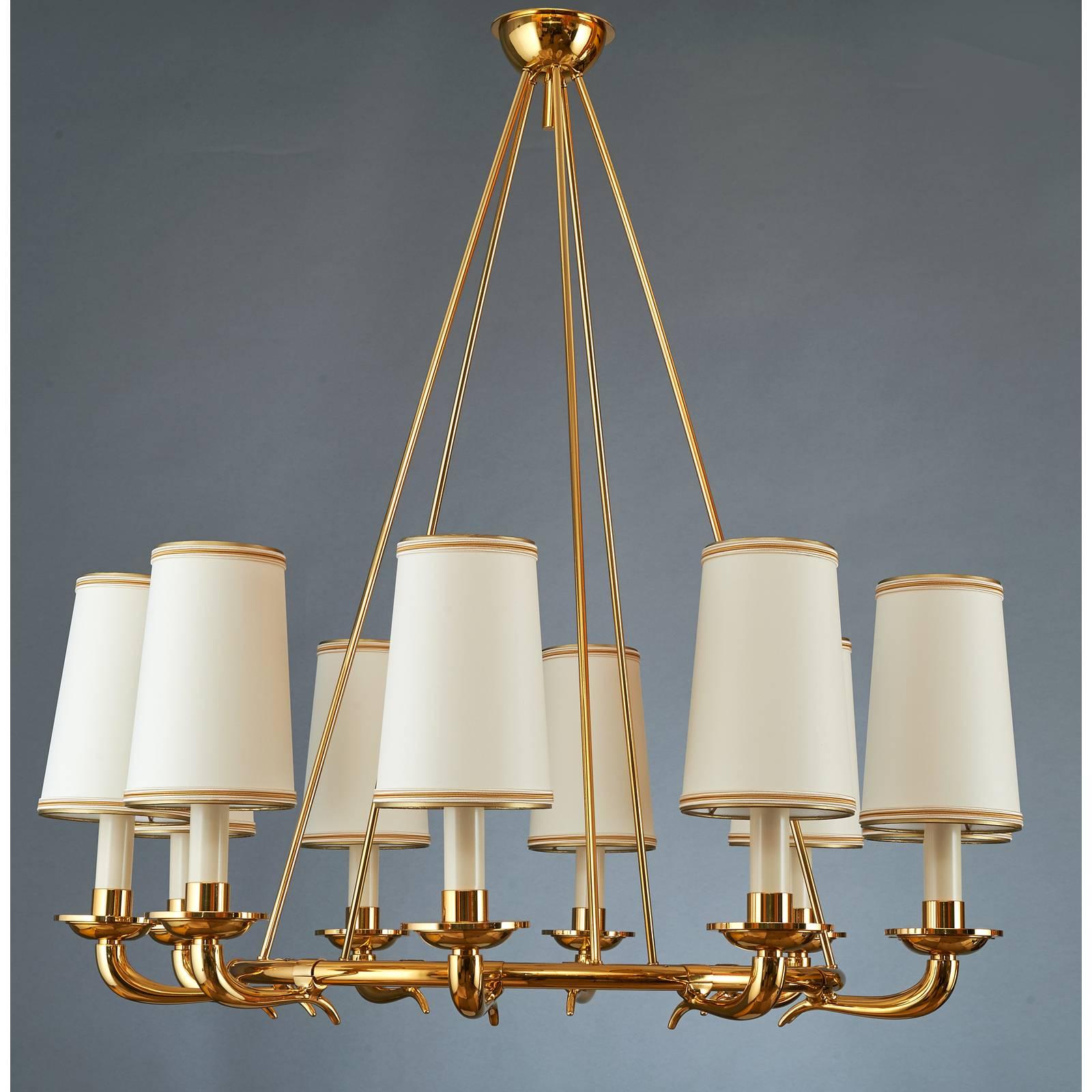Italy, 1950s
An elegant ten branch chandelier in polished brass 
with gracefully styled cornucopia arms mounted on a
suspended circular frame.
34 diameter x 35 H
Rewired for use in the USA.