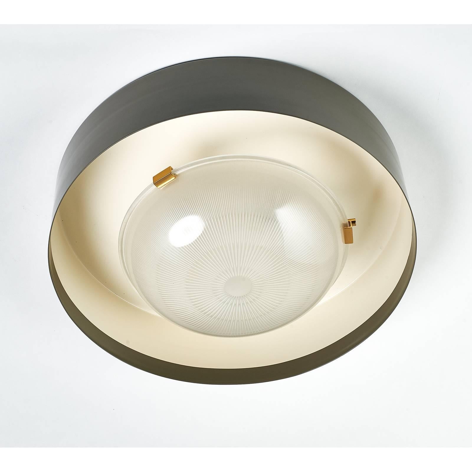 IGNAZIO GARDELLA FOR AZUCENA

Flush mount ceiling fixture designed by Ignazio Gardella for Azucena, early 1960's. 
A rarely seen model (LP5 Sestrière). 
Ribbed cast frosted glass with gray enameled metal shade, polished brass mounts 
Rewired for use