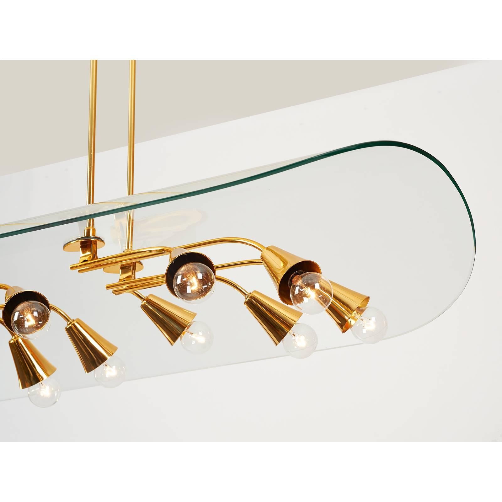 Pietro Chiesa (1892-1948) for Fontana Arte
A rare and extraordinary large twenty-branch polished brass chandelier
sheltered under a magnificent canopy of curved molded glass 
Italy, circa 1950. Stamped with maker's mark.
Dimensions: 65 x 24 x 47