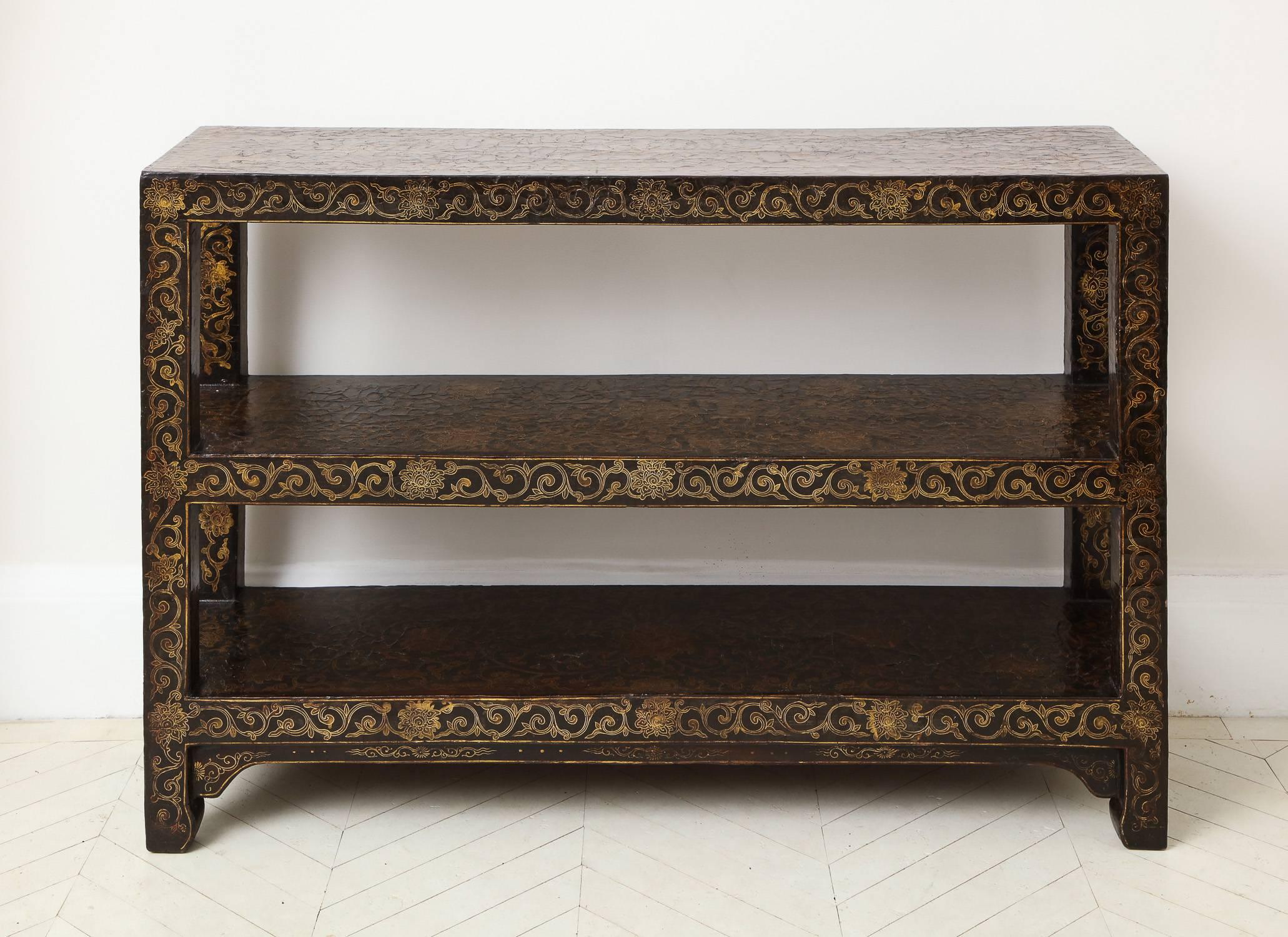 A rare 18th century Chinese gilt-decorated lacquer bookshelf with all-over floral decoration. 

Provenance: Mr. & Mrs. Paul Mellon, New York.