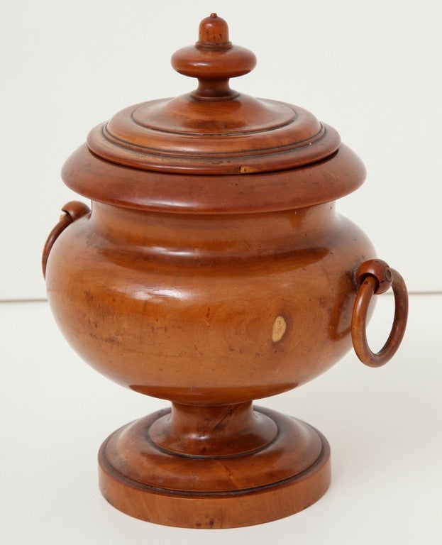 An early 19th century English turned boxwood lidded urn with ring-turned handles