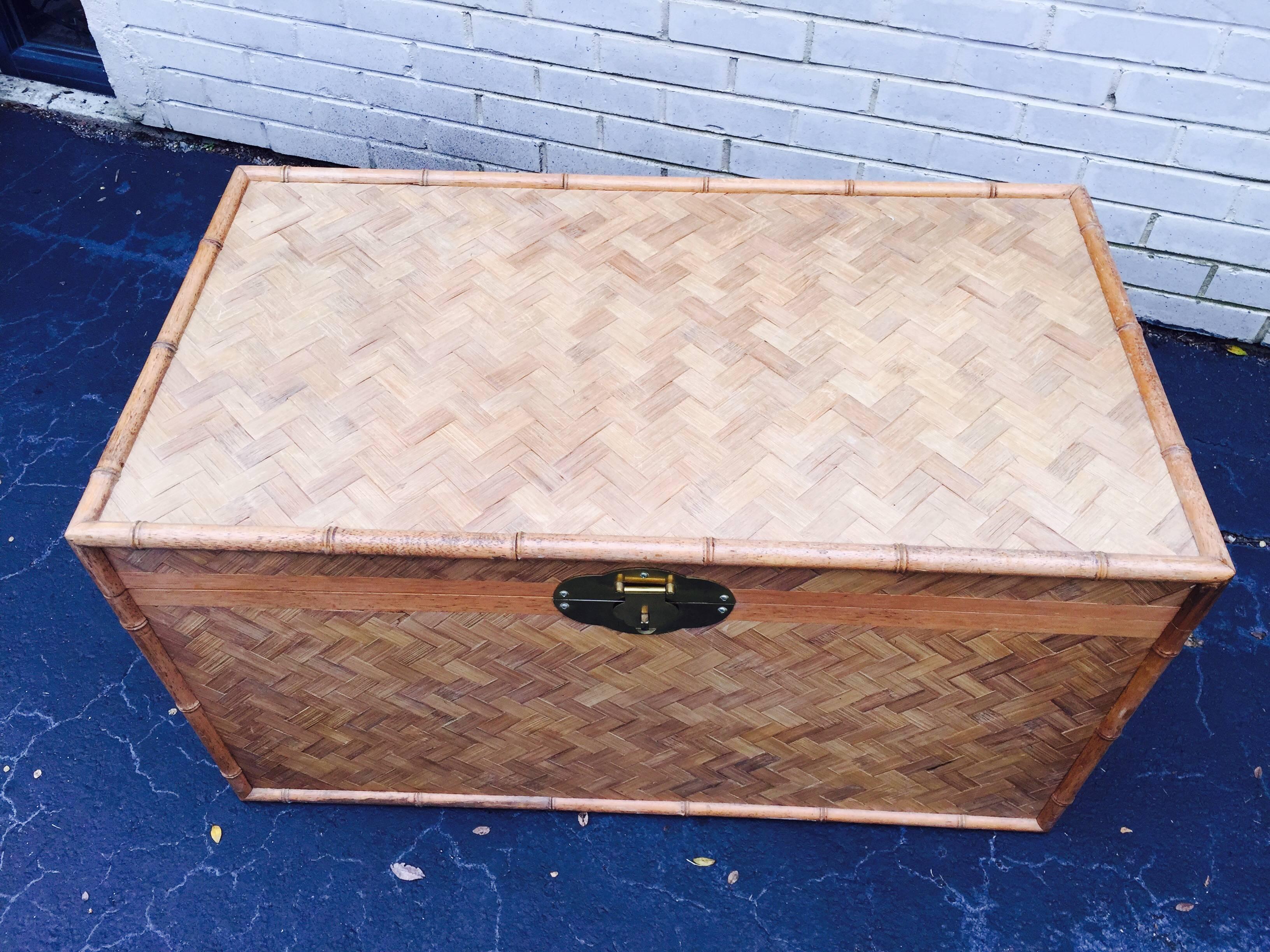 Large Bamboo and Woven Cane Sculptural Trunk Table possibly by Sarreid. This beautiful piece is comprised of real woven cane with thick bamboo along the edges and sculptural brass hardware. it has tons of room for storage inside and is very sturdy