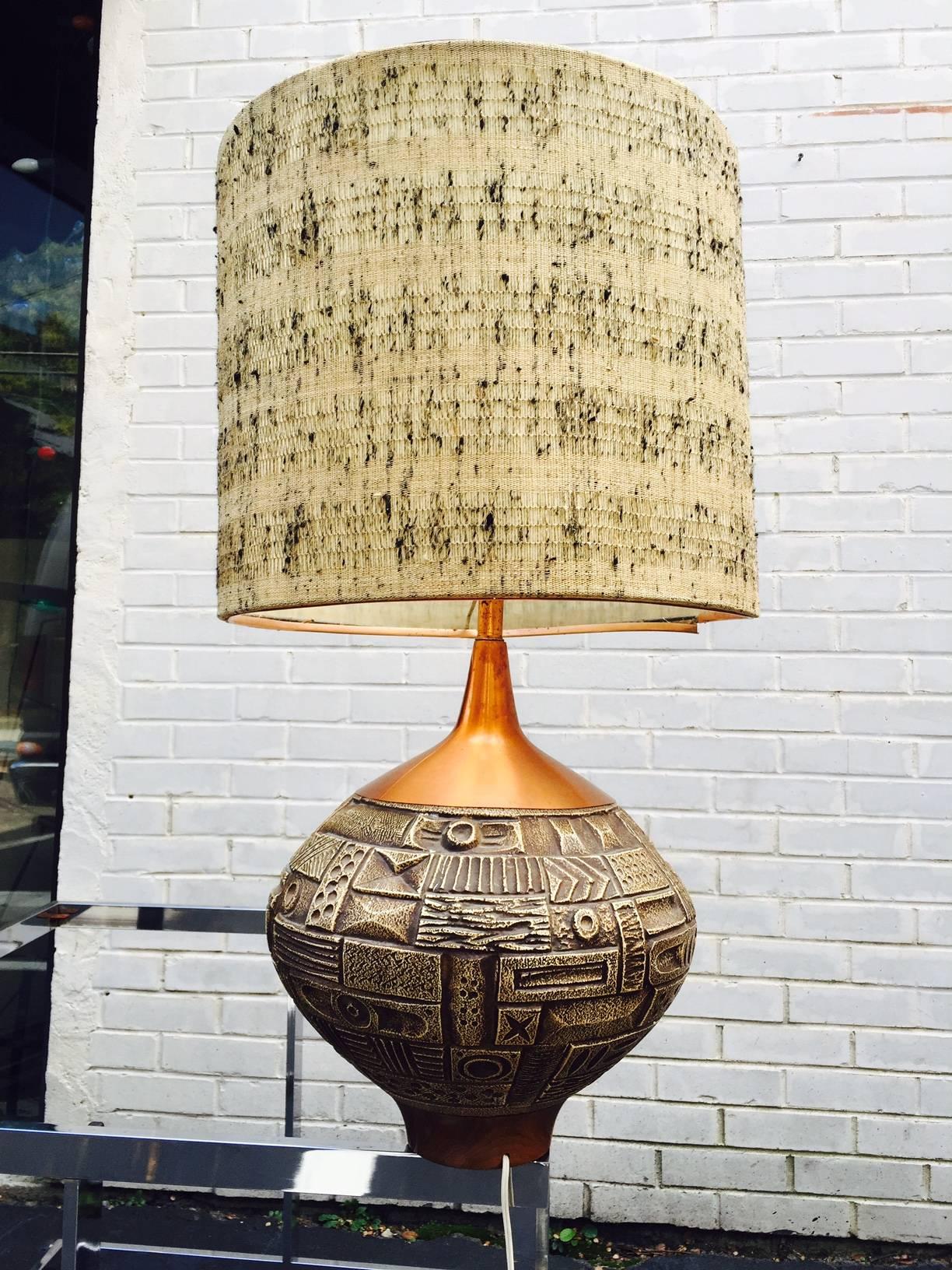 Mid-Century large sculptural pottery and copper table lamp in the style of martz. This unique design is comprised of a sculpted bulbous pottery body with copper accents and turned wood base. Original shade is attached but could easily be replaced if