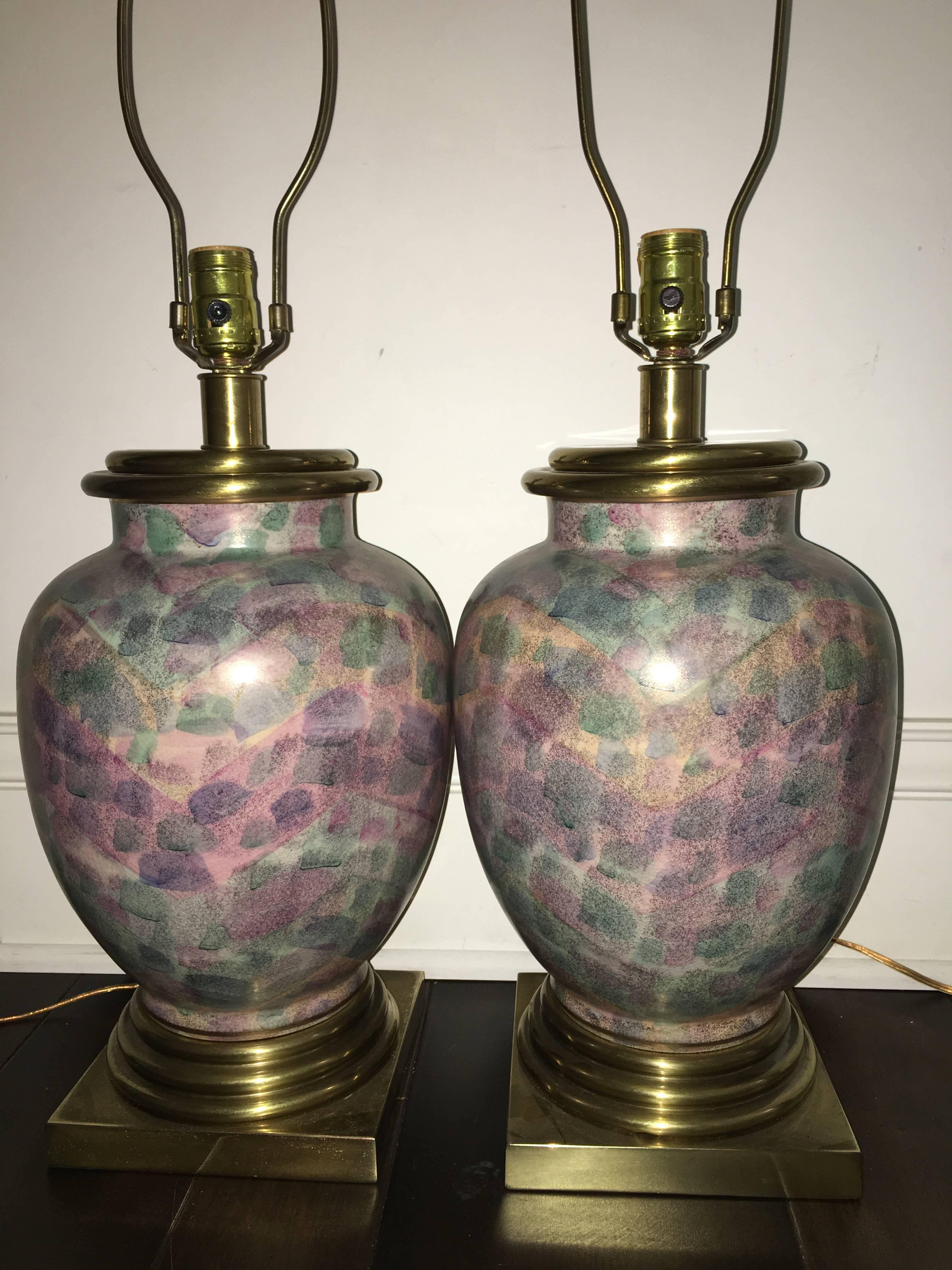 Exceptional pair of multi-colored ceramic table lamps by Frederick Cooper. This unique pair are each comprised of colorful ceramic with brass bases and finials. Lamps are rewired and ready to use. Truly a beautiful pair in person.