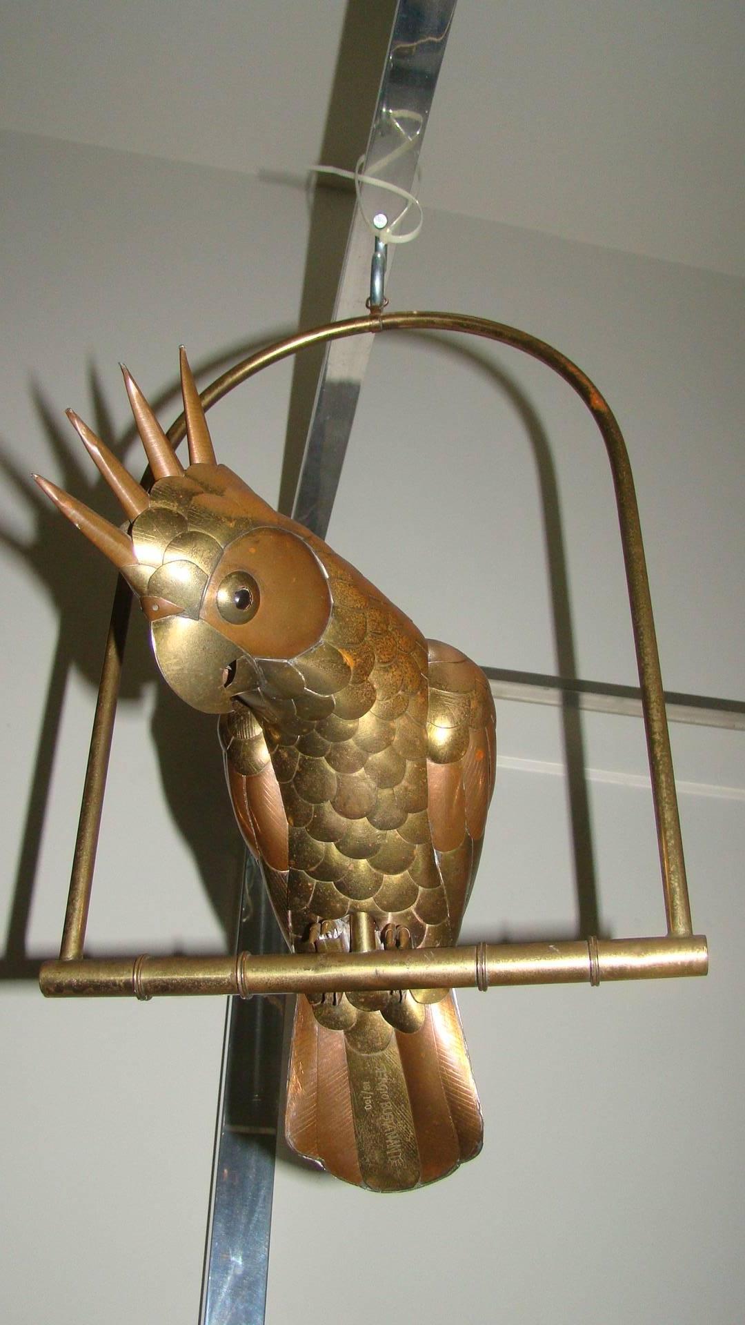Terrific mixed metal hanging cockatoo sculpture by Mexican Master Sergio Bustamante. This interesting piece depicts a unique spiky haired Parrot resting on perch. It is constructed of hand welded brass and copper. Signed and numbered 13/100.