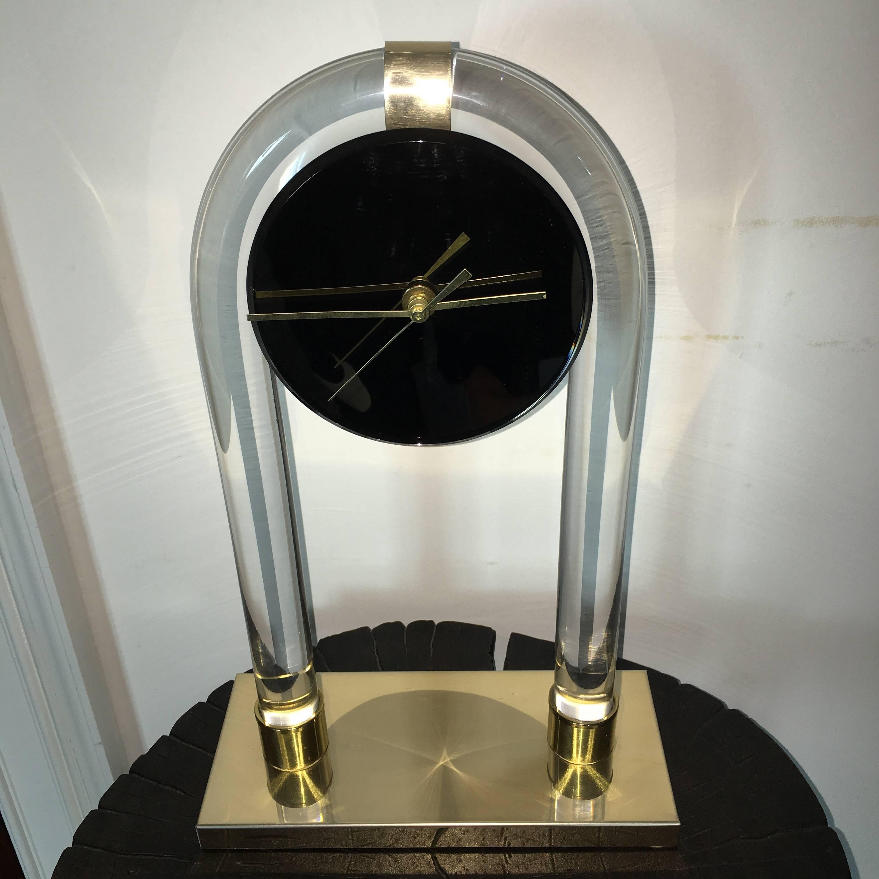 Great vintage sculptural Lucite table clock. This interesting design is comprised of thick tubed Lucite with mirrored face and brass accents. Quartz mechanism works smooth.
