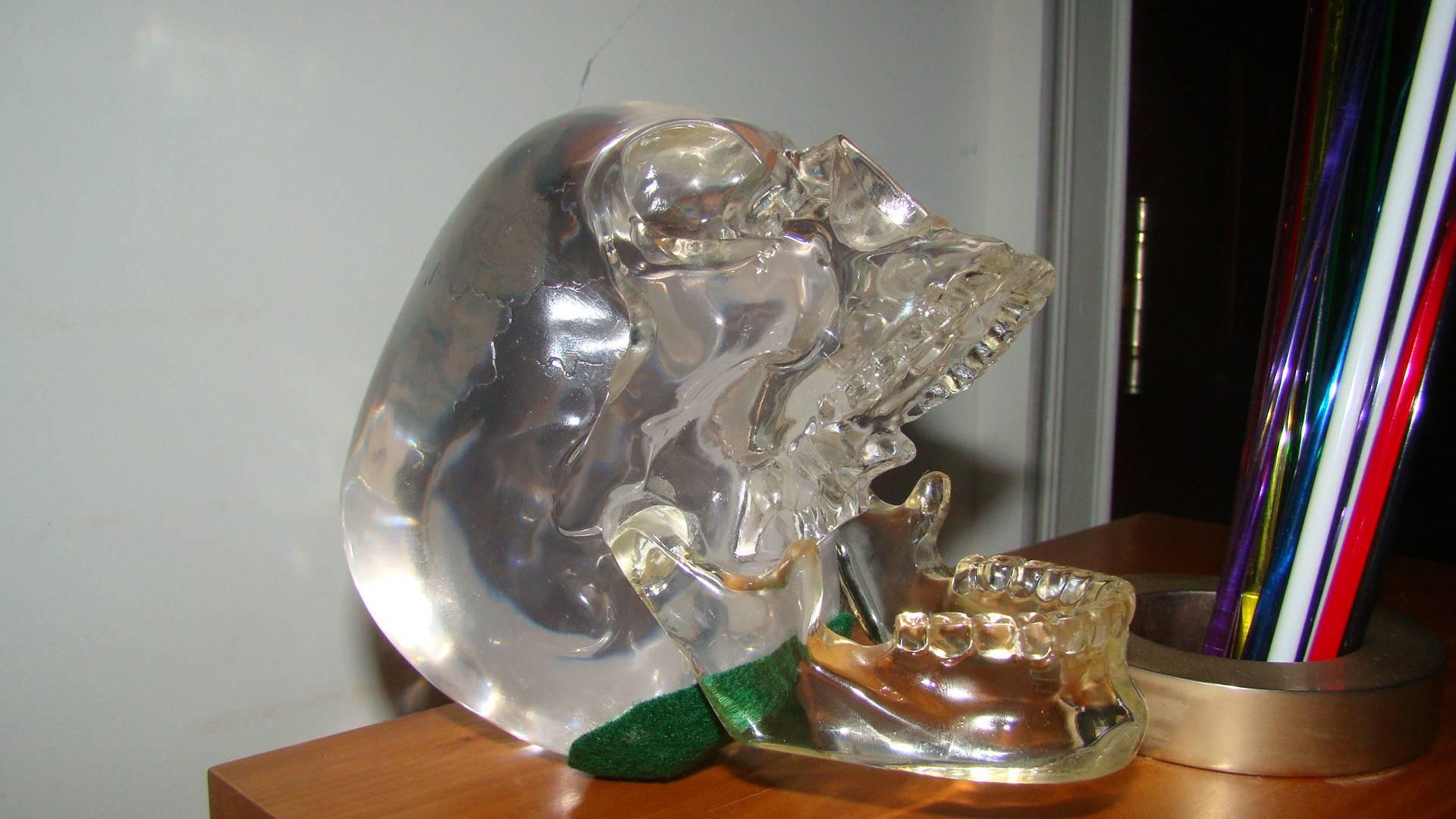 Terrific Mid-Century solid Lucite skull sculpture, circa 1970s. This interesting piece is comprised of clear Lucite with movable jaw. Said to have been sold by Harrods London. Great conversation piece for your desk.
