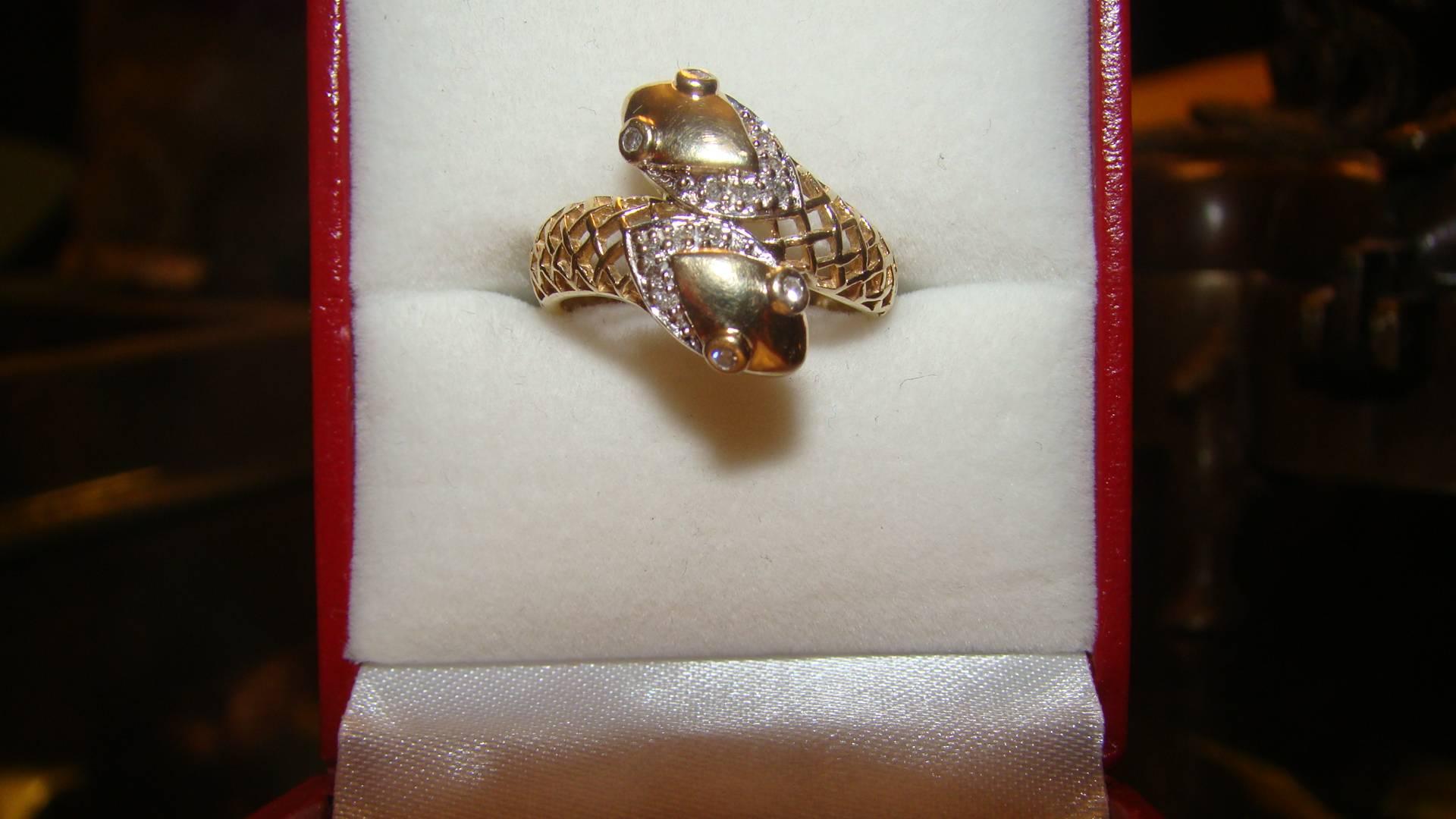 Beautiful Art Deco antique 14-karat yellow gold double headed snake ring with diamond eyes and diamond scales along both heads. The ring is a size 5.5. Diamonds are vintage and real with bright shine. Truly a beautiful snake ring in person.