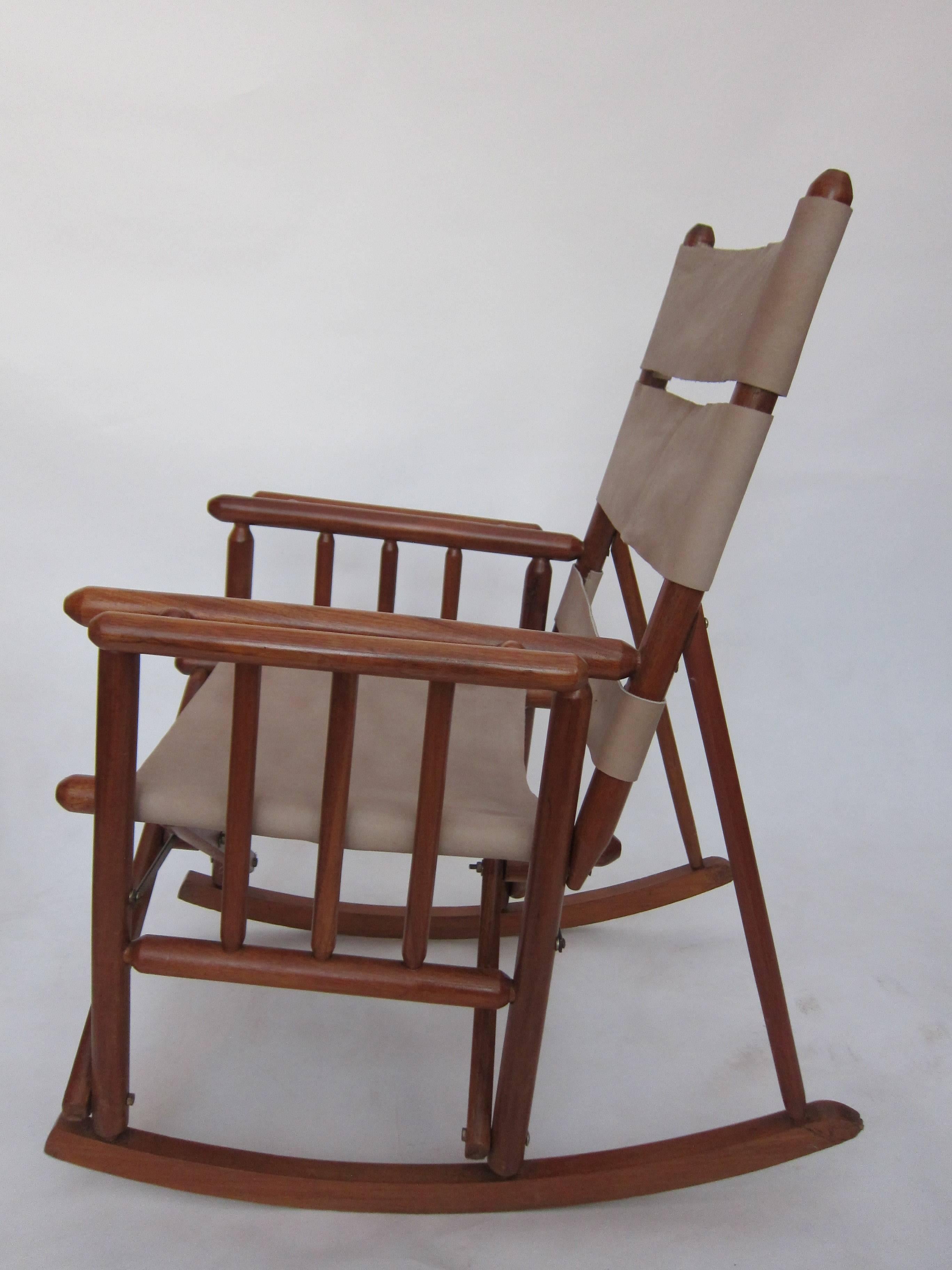 A handsome pair of collapsible spindle rocking chairs crafted of tropical wood and leather. From Costa Rica, 1960s and extremely comfortable.  