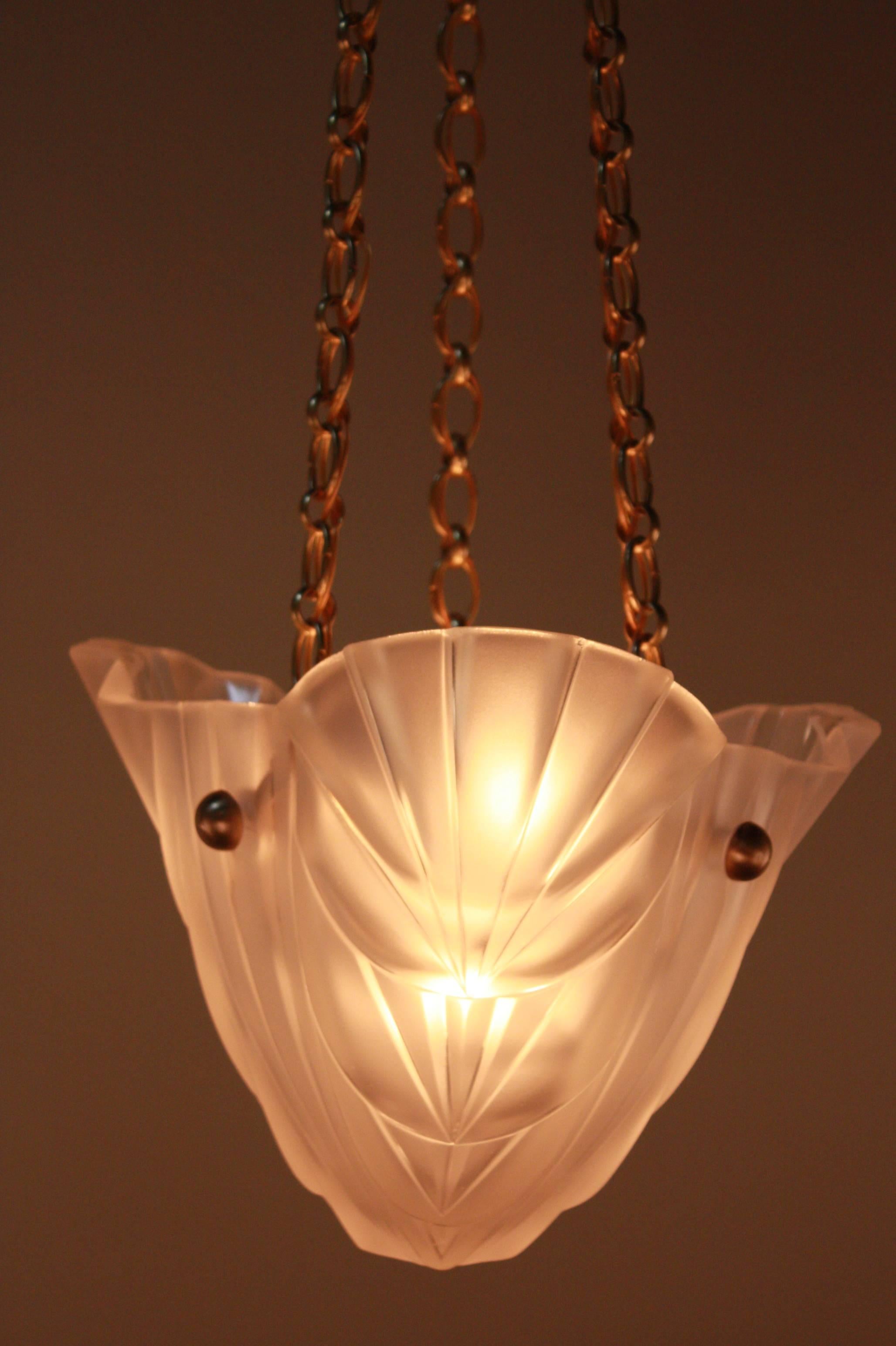 A fabulous pair of Art Deco glass chandelier with elegant bronze chain and canopy by Degue.
Six-light 60watt each.
Height can be adjusted by removing some of the chain.