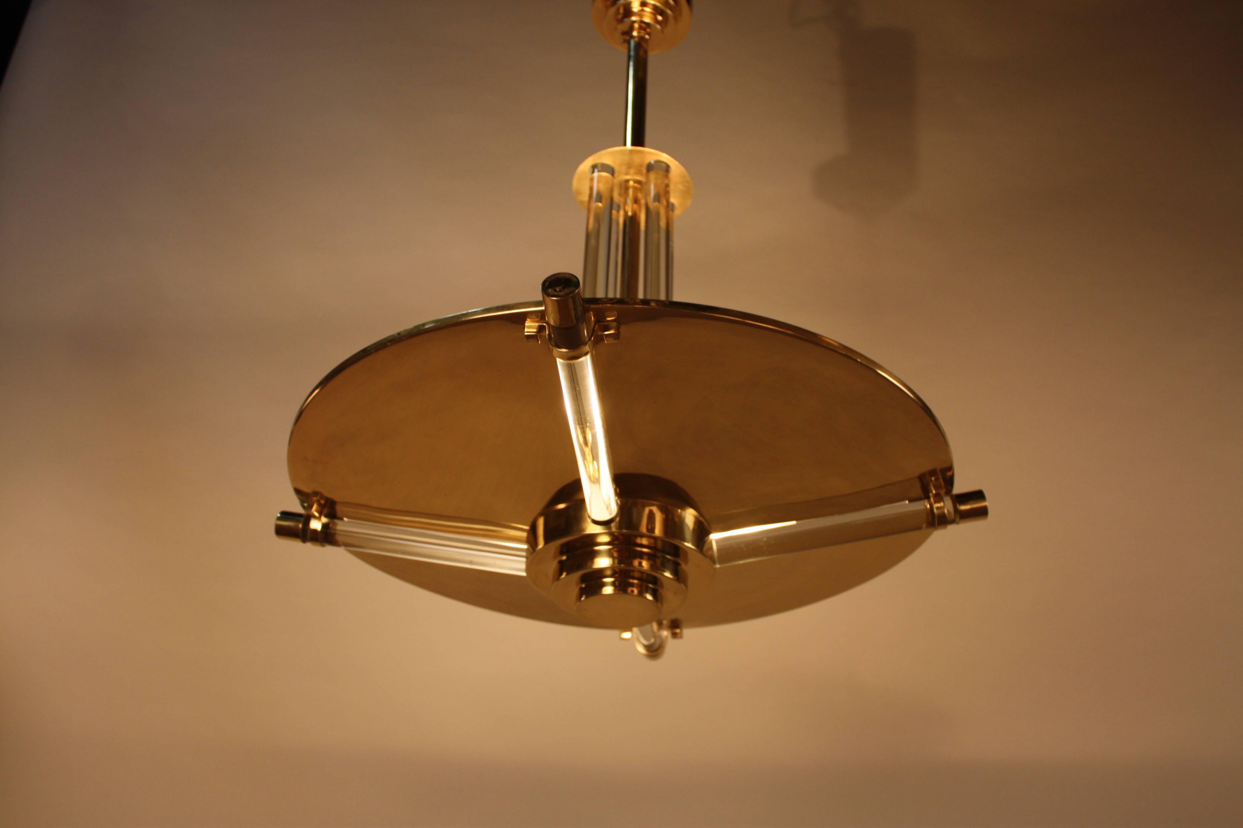 Simple but elegant, combination of bronze and glass rods chandelier. Cut in the large disc allows light to shine through glass rods.
Eight lights, 60watts each.