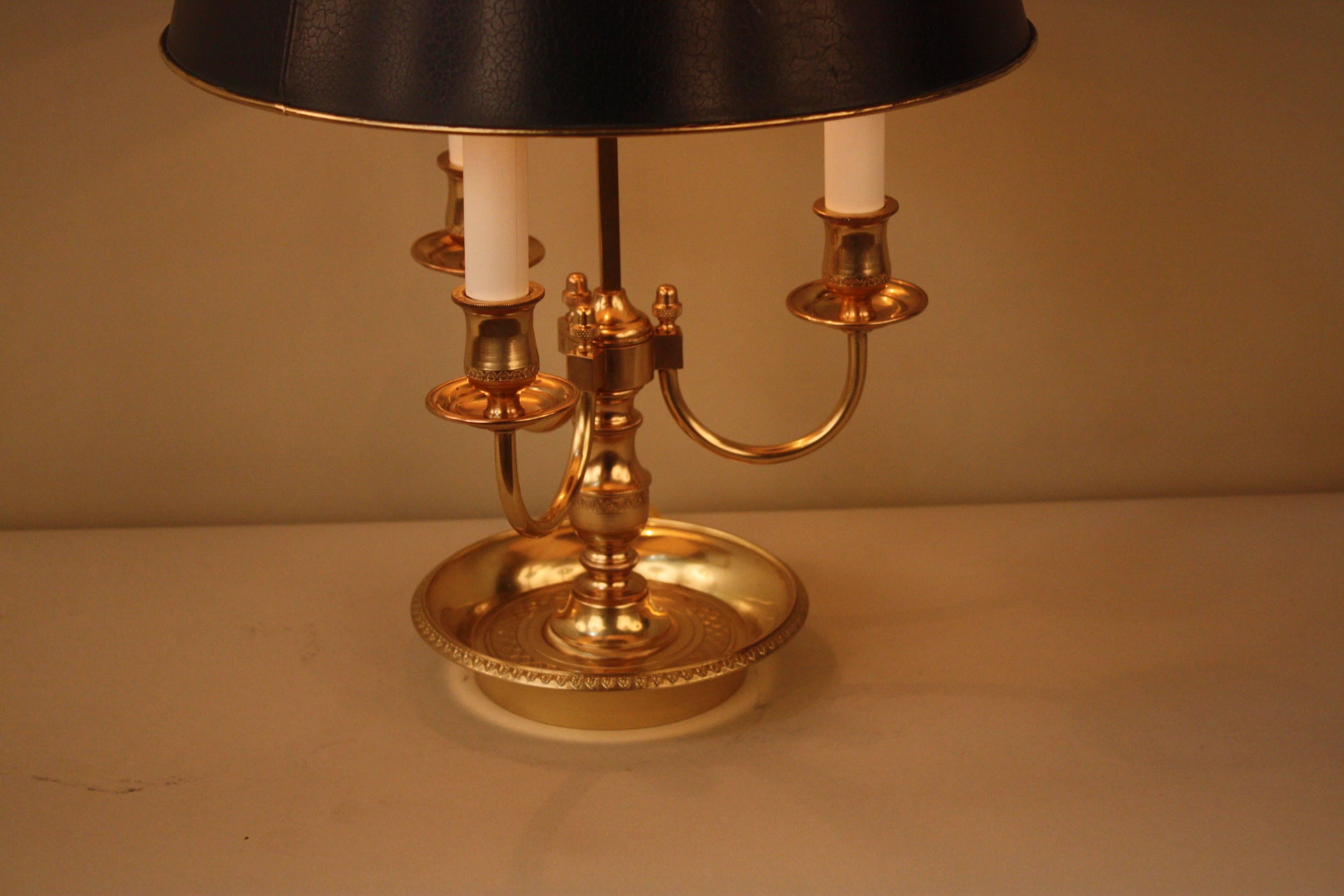 French 1920s three-light bronze desk lamp with adjustable painted metal shade.