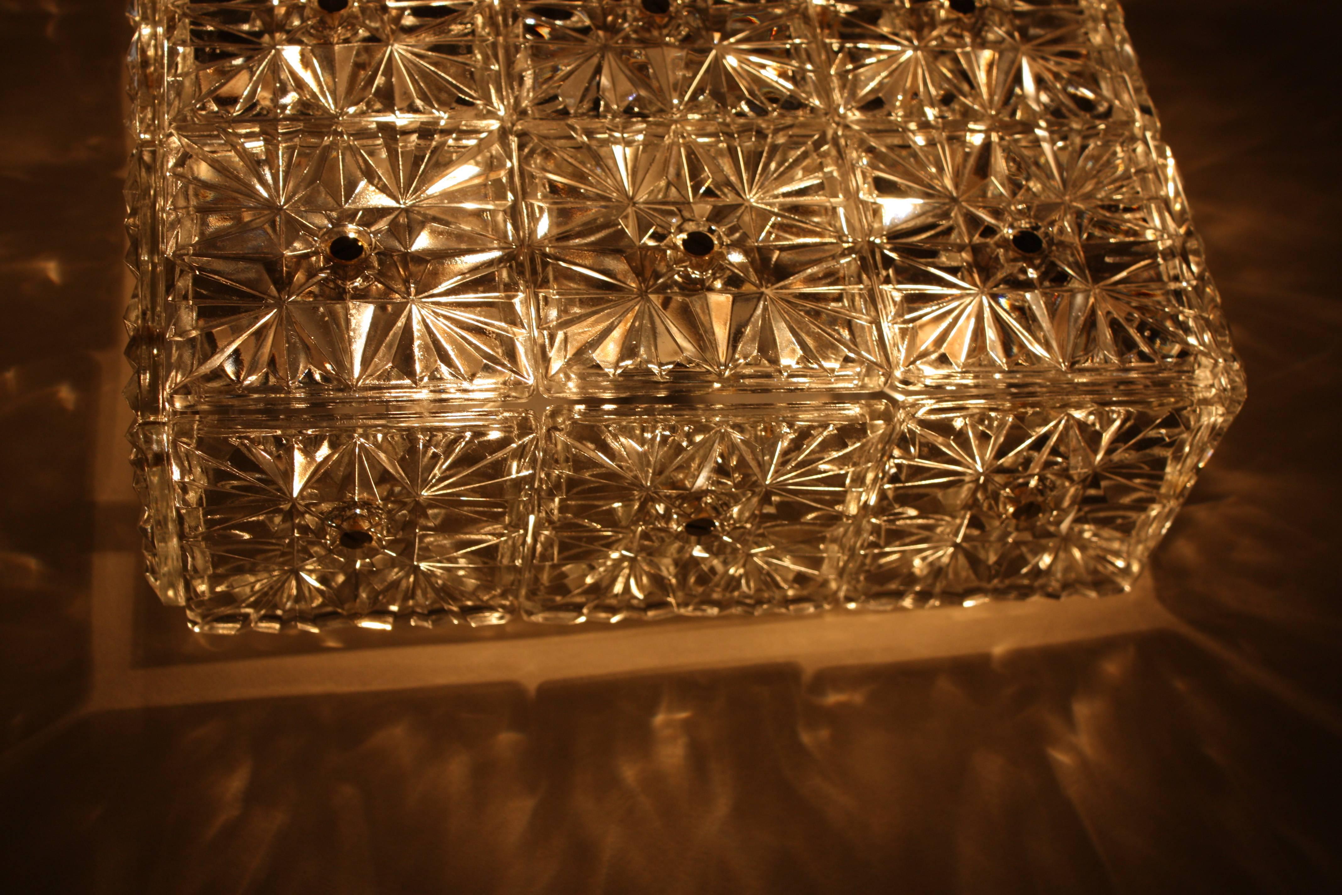 Square flush mount light with total of twenty one prismatic glass.