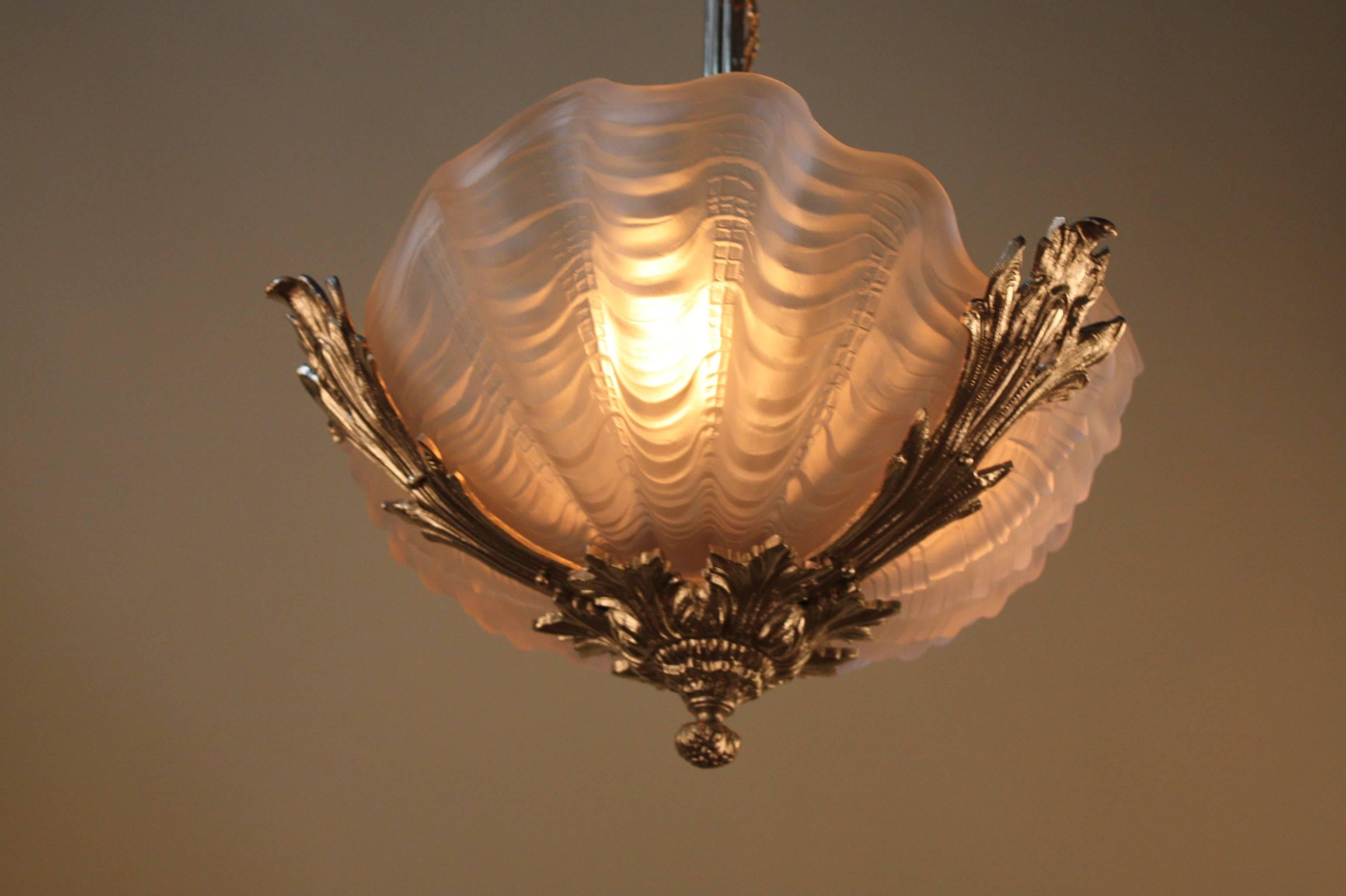 An elegant art deco chandelier with sea shell glass shades and beautiful  nickel on bronze body.