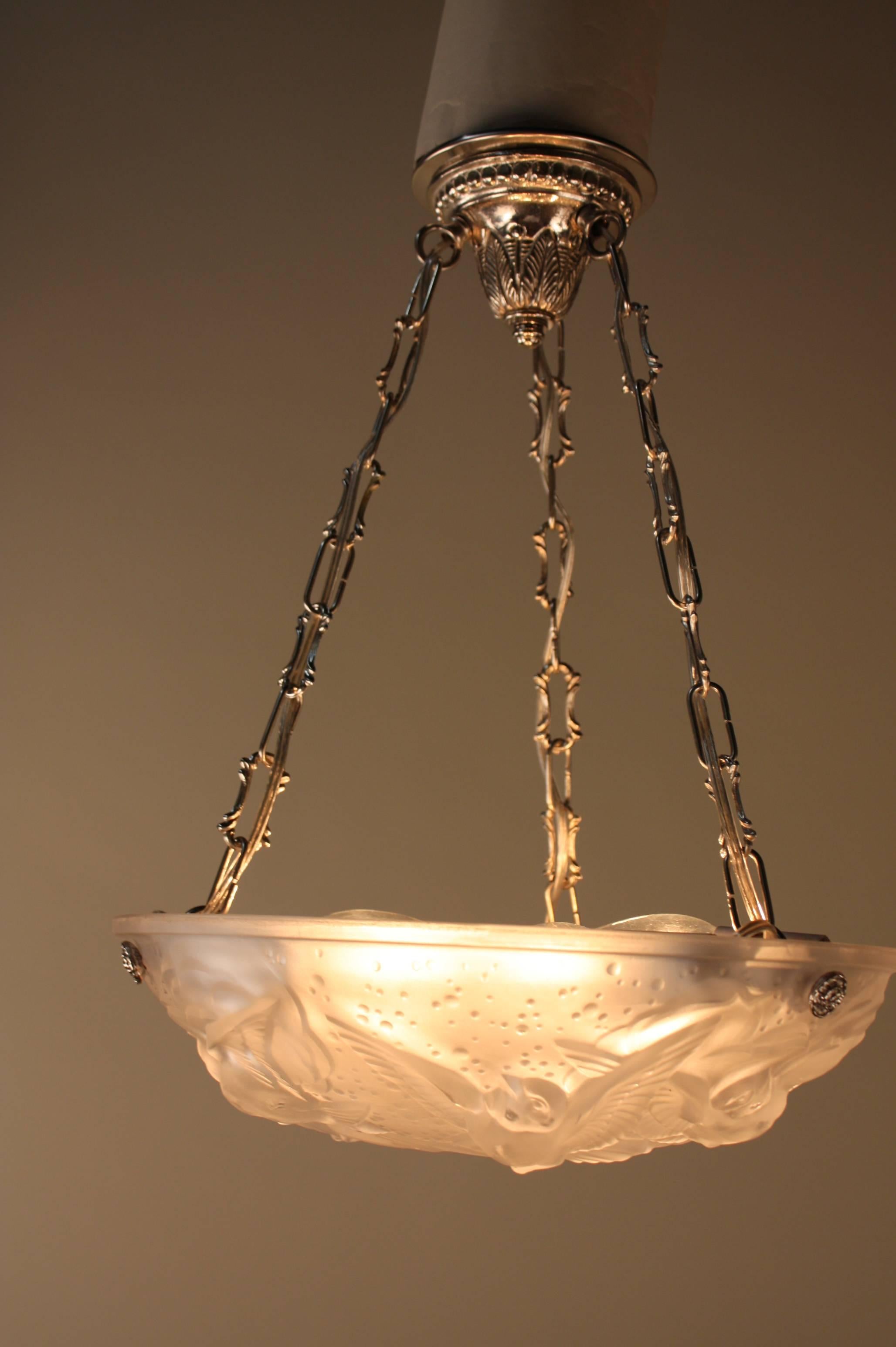 Wonderful six light Art Deco glass with flying bird's motion pendant/chandelier with nickel on bronze hardware by Muller Frères. 
We have simile chandelier in pair.