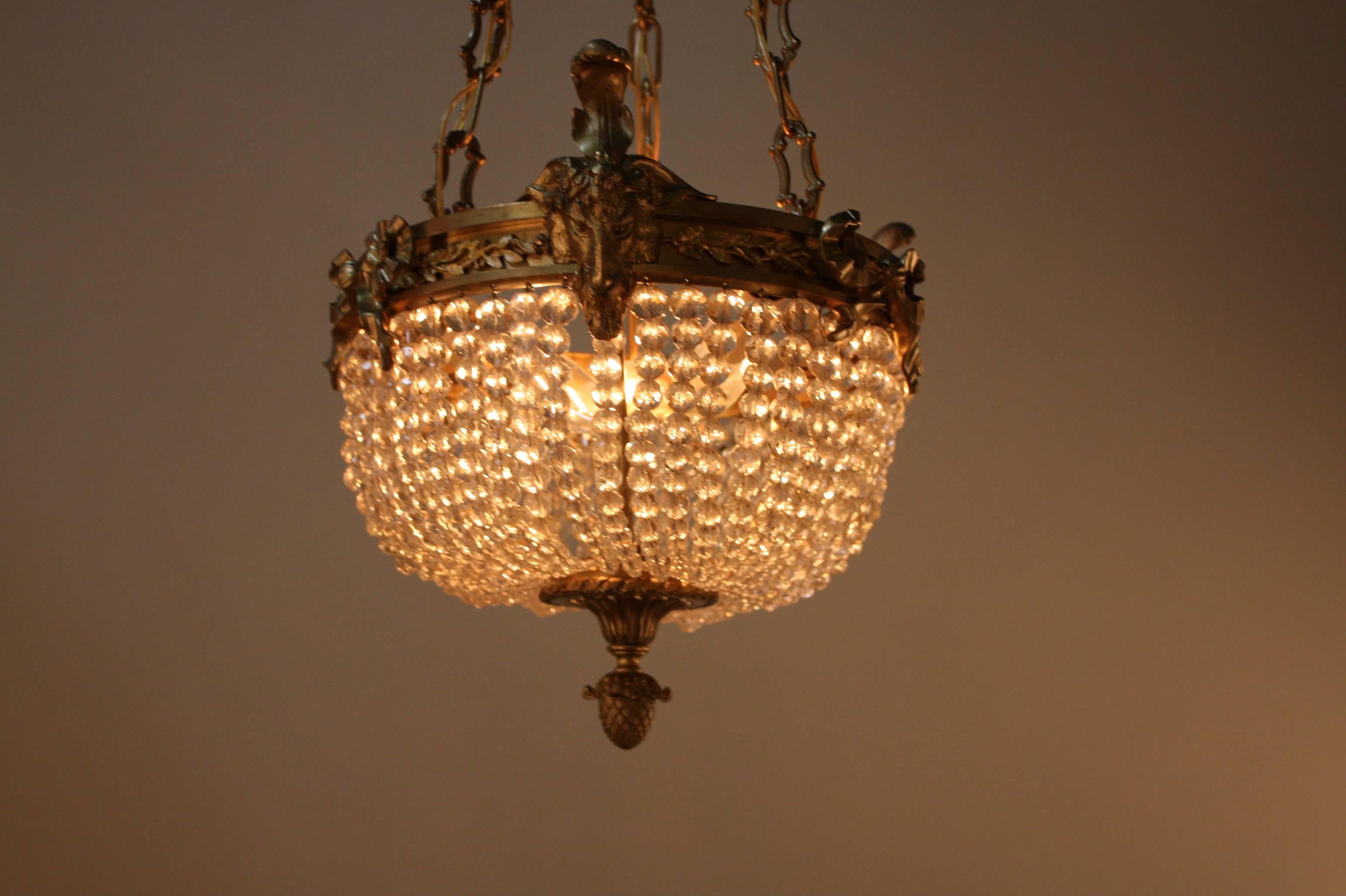 Elegant three-light petite crystal chandelier with wonderful bronze hardware.