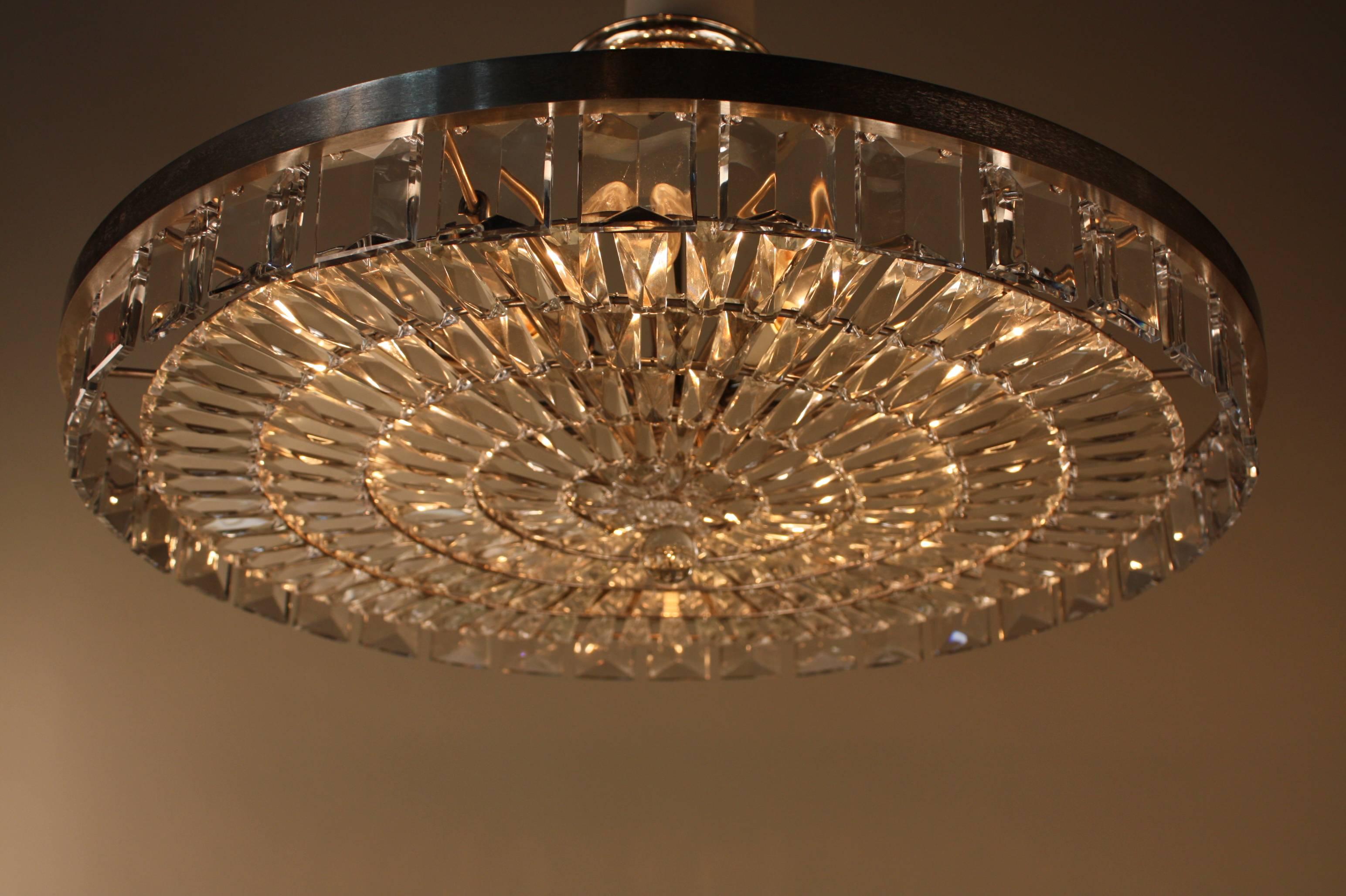 Simple but elegant twelve light large crystal flush mount ceiling light made of hundreds of fine Austrian crystal with nickel on bronze frame. 
This chandelier is 27