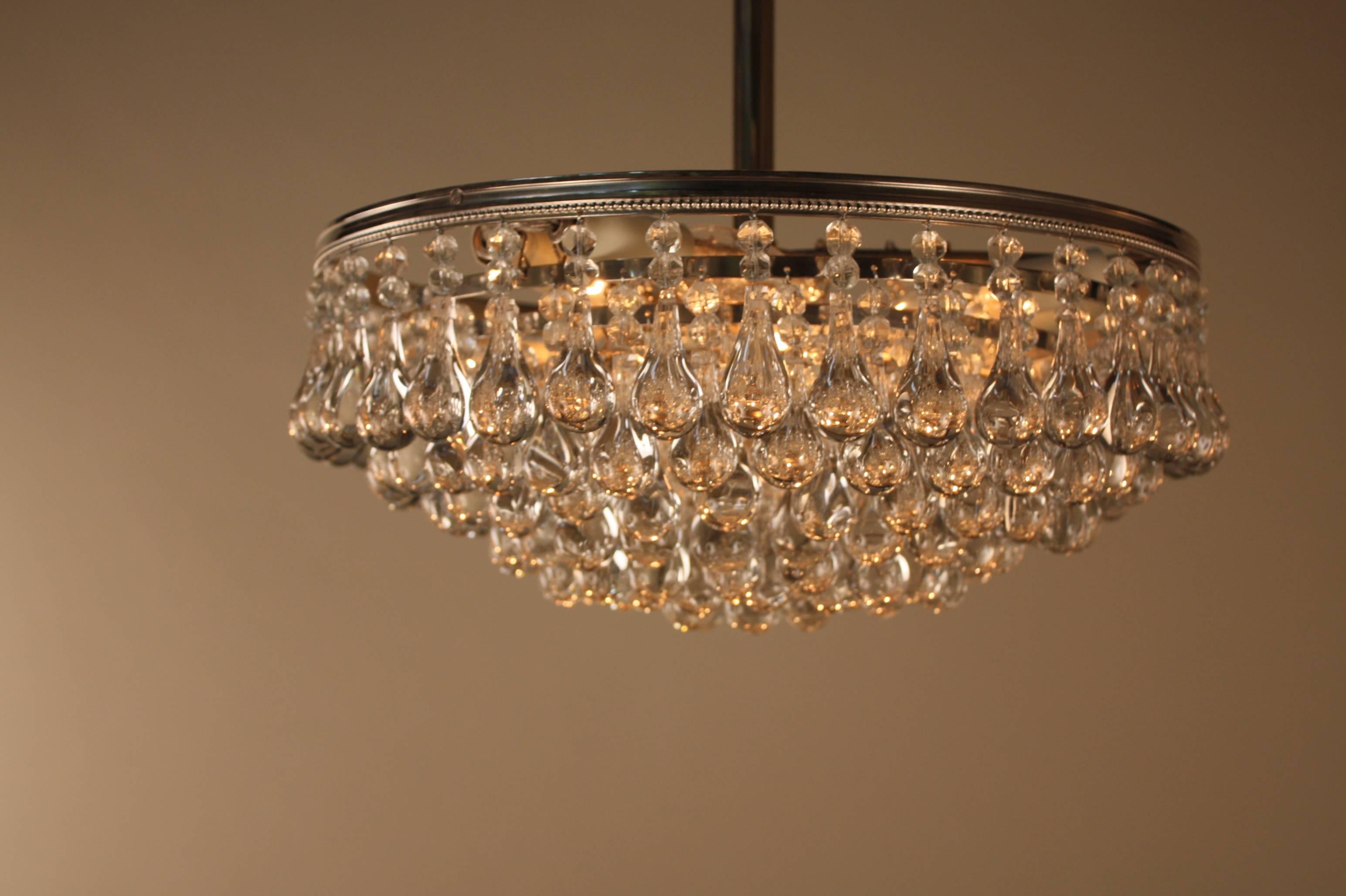 Wonderful six-light tear drop crystal semi flush mount chandelier with nickel on bronze frame.