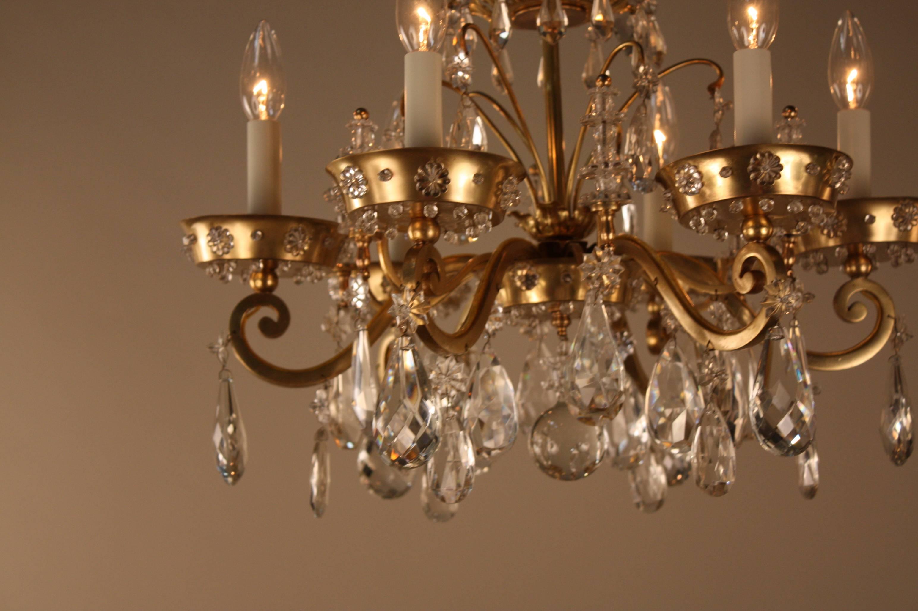 An impressive six lights with beautiful bronze design and high quality cut crystal chandelier by Maison Baguès.