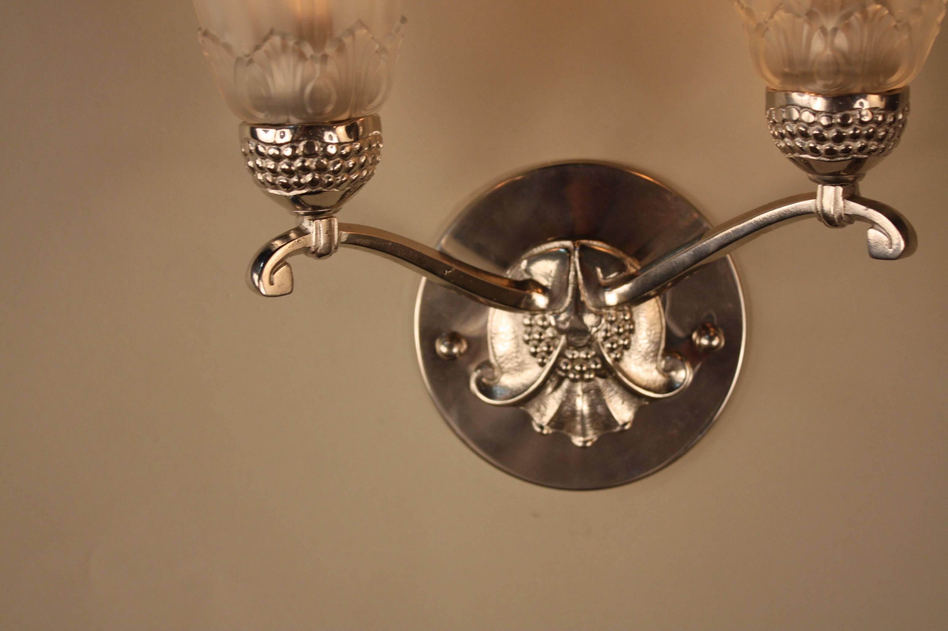 A fantastic pair of double arm nickel on bronze beautiful glass shade wall sconces.