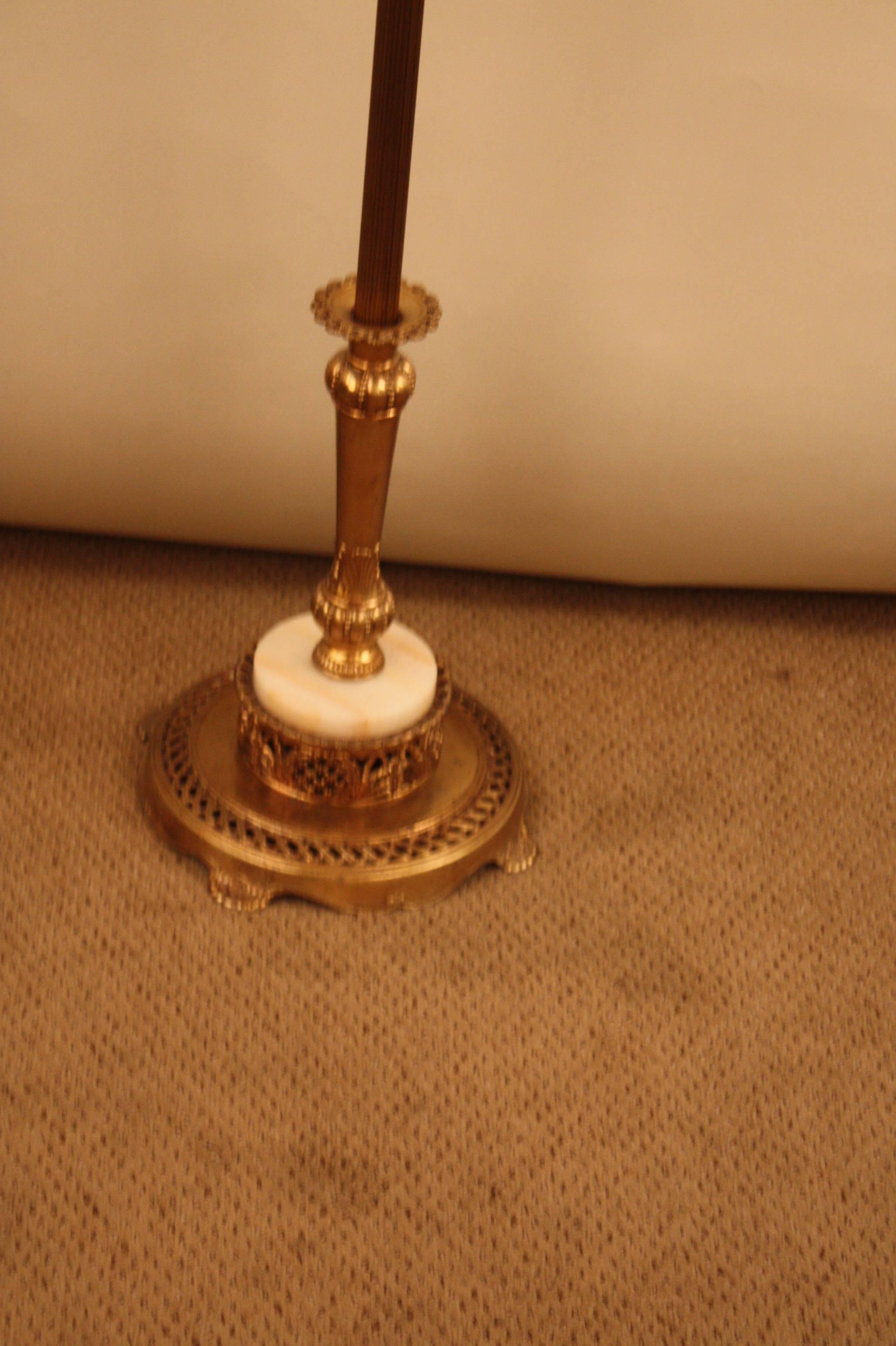 Elegant American Art Deco torchiere floor lamp with beautiful gold color and original glass shade.
