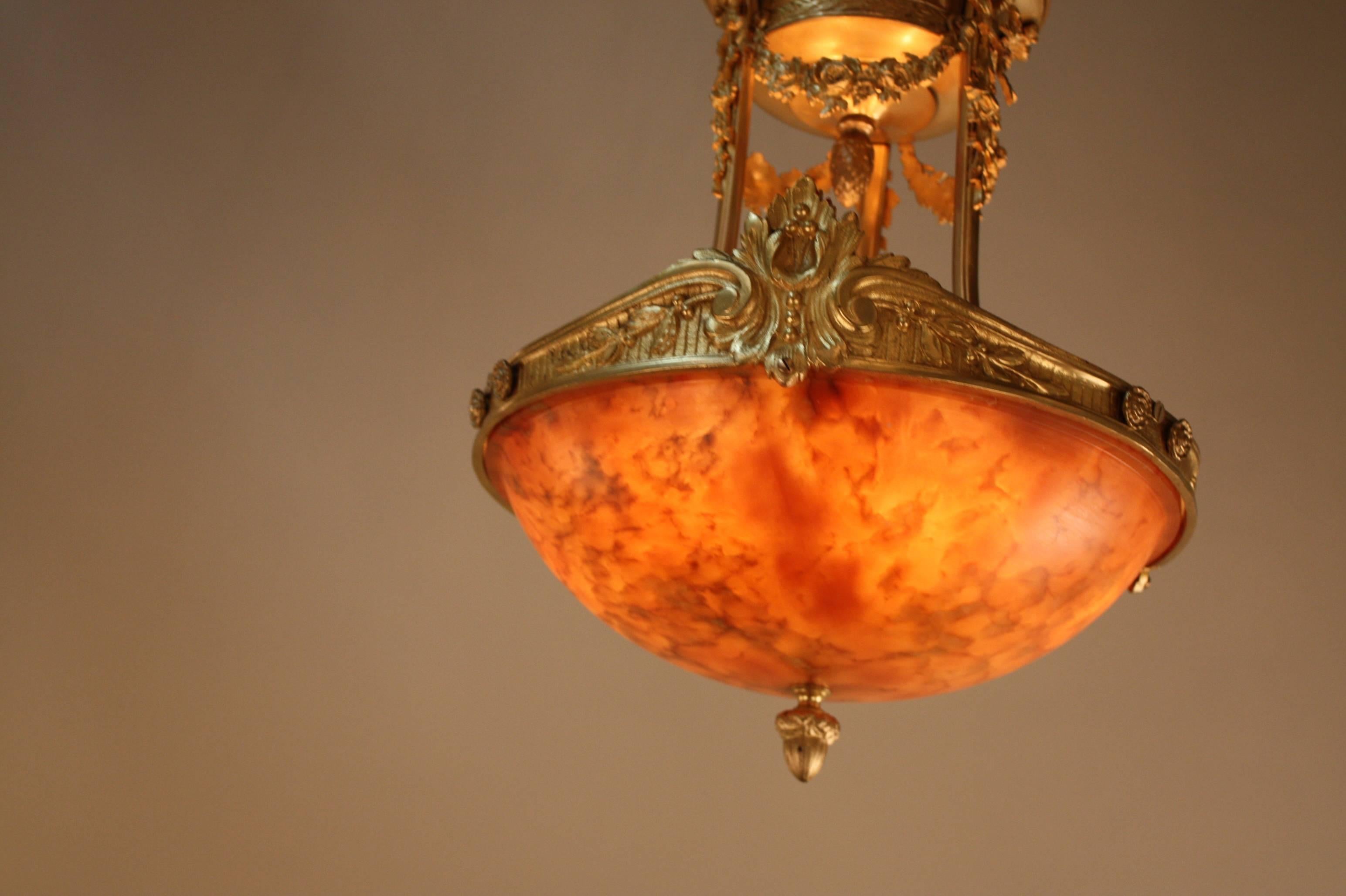 This honey and amber colored semi flush alabaster chandelier will add elegant and beauty to any room. The natural texture of the alabaster with bronze decoration and framing adds a uniqueness to this piece.
